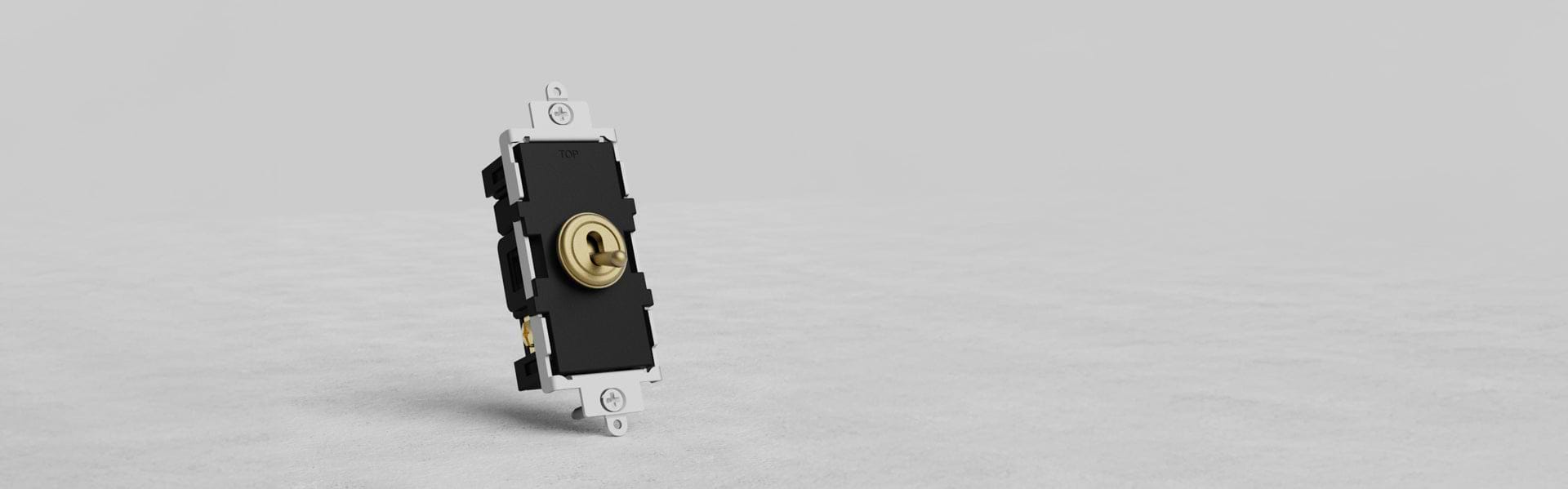 A close-up of a brass electrical switch with a round toggle in the center, mounted on a white base, set against a light gray background.