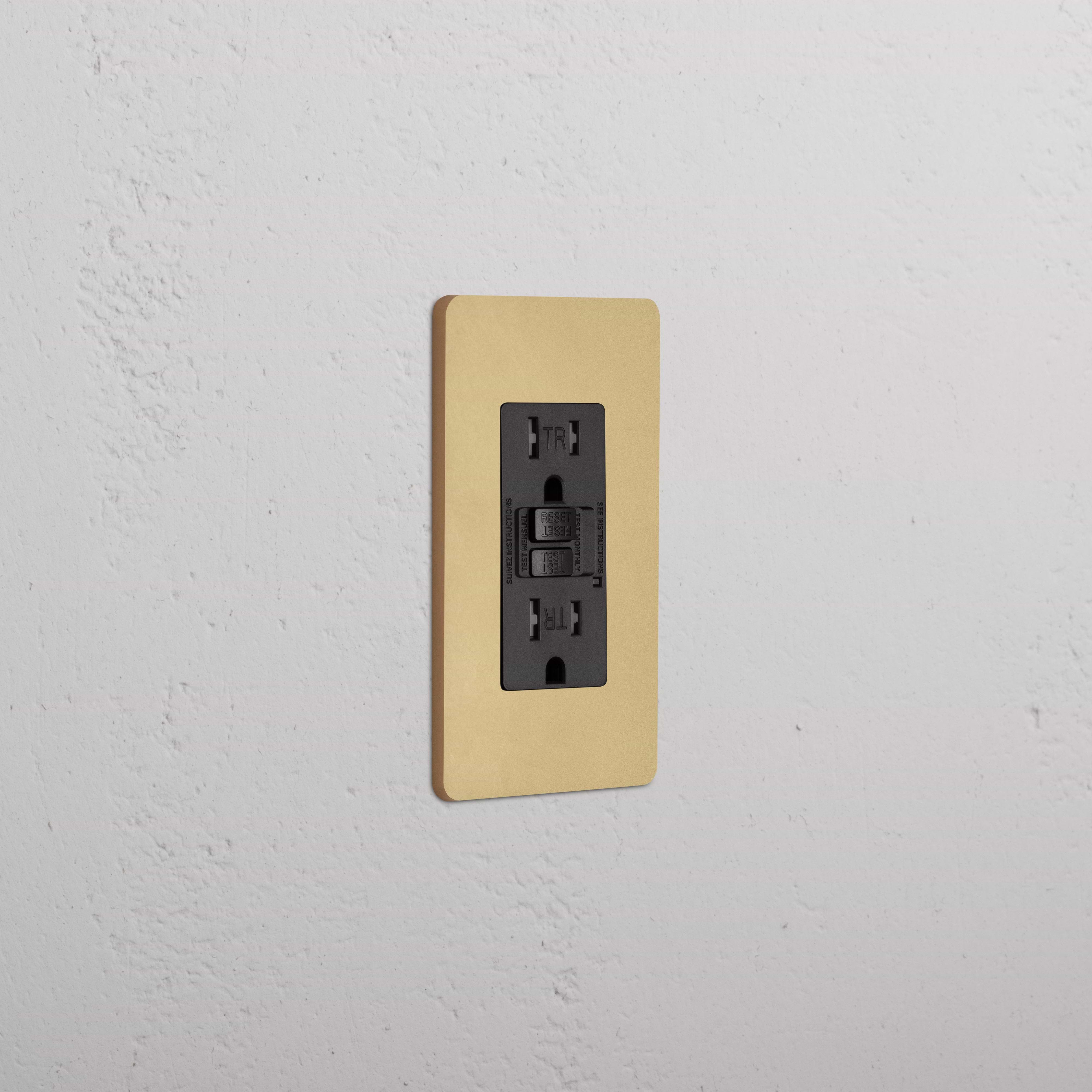 Grove 1G 15A GFCI Outlet in Antique Brass Black finish with test and reset buttons on a wall plate.