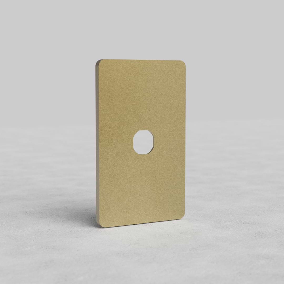 Antique Brass 1G Switch Plate Grove US with rounded corners and central switch cutout on a light surface.