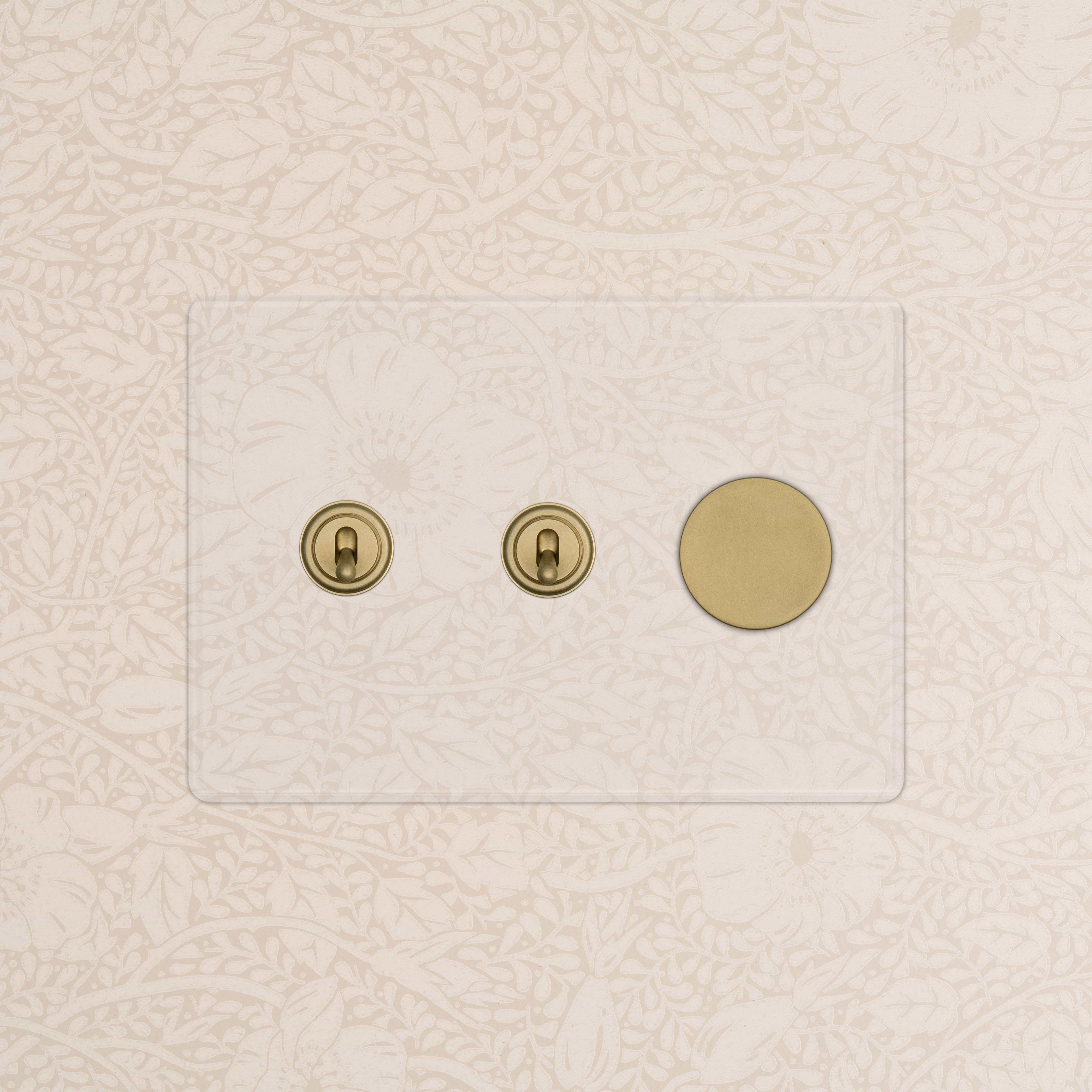 Kew 3G 2x Toggle & Dimmer Switch in Clear Antique Brass with two toggles and one dimmer on a brass plate.
