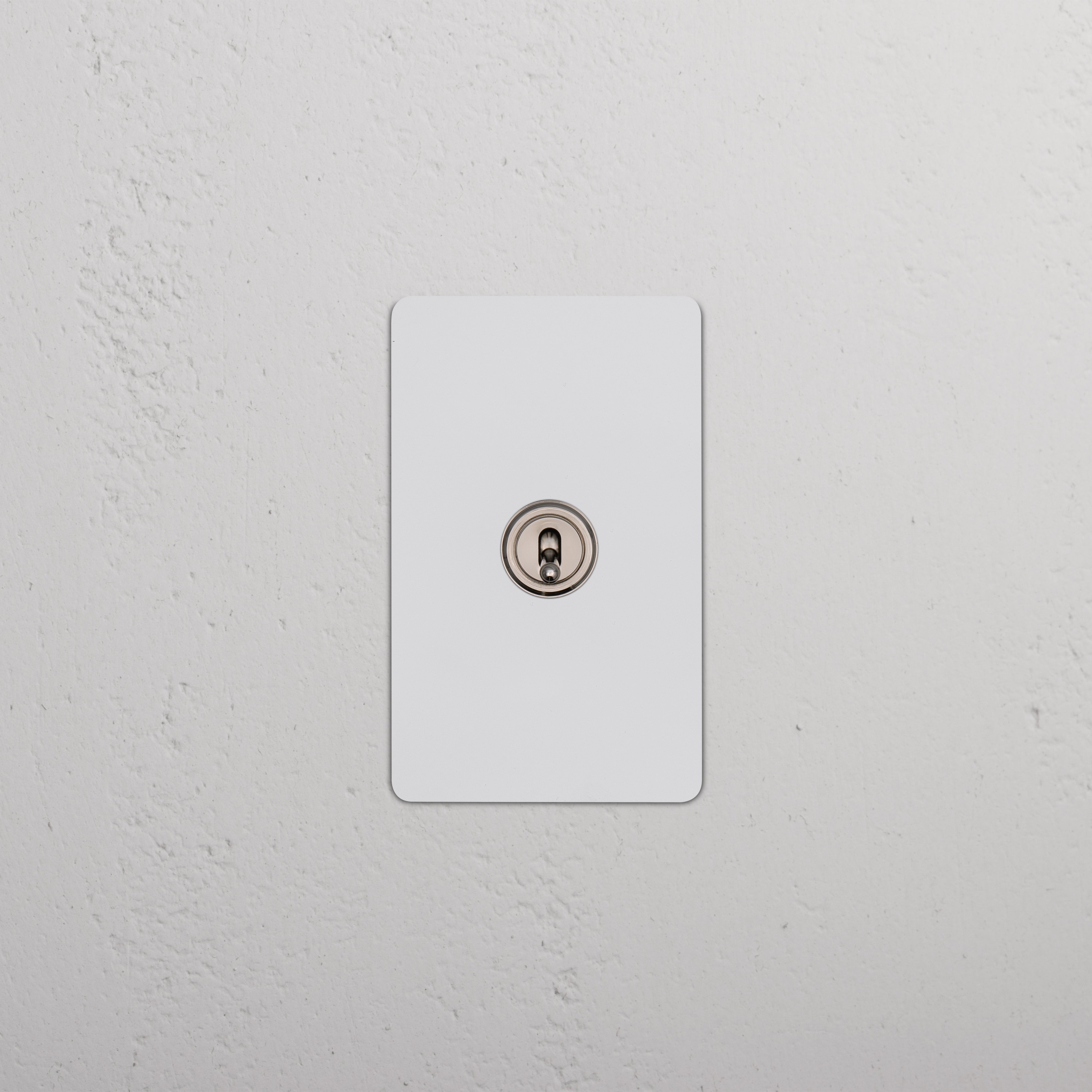Kew 1G Four Way Toggle Switch in paintable polished nickel finish, mounted on a white wall plate.