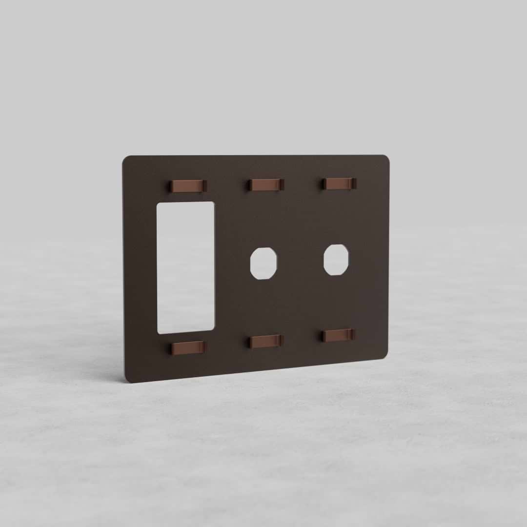 Bronze 3G 2x Switch & Outlet Plate Kew US, rectangular with two switch and one outlet openings, on gray surface.