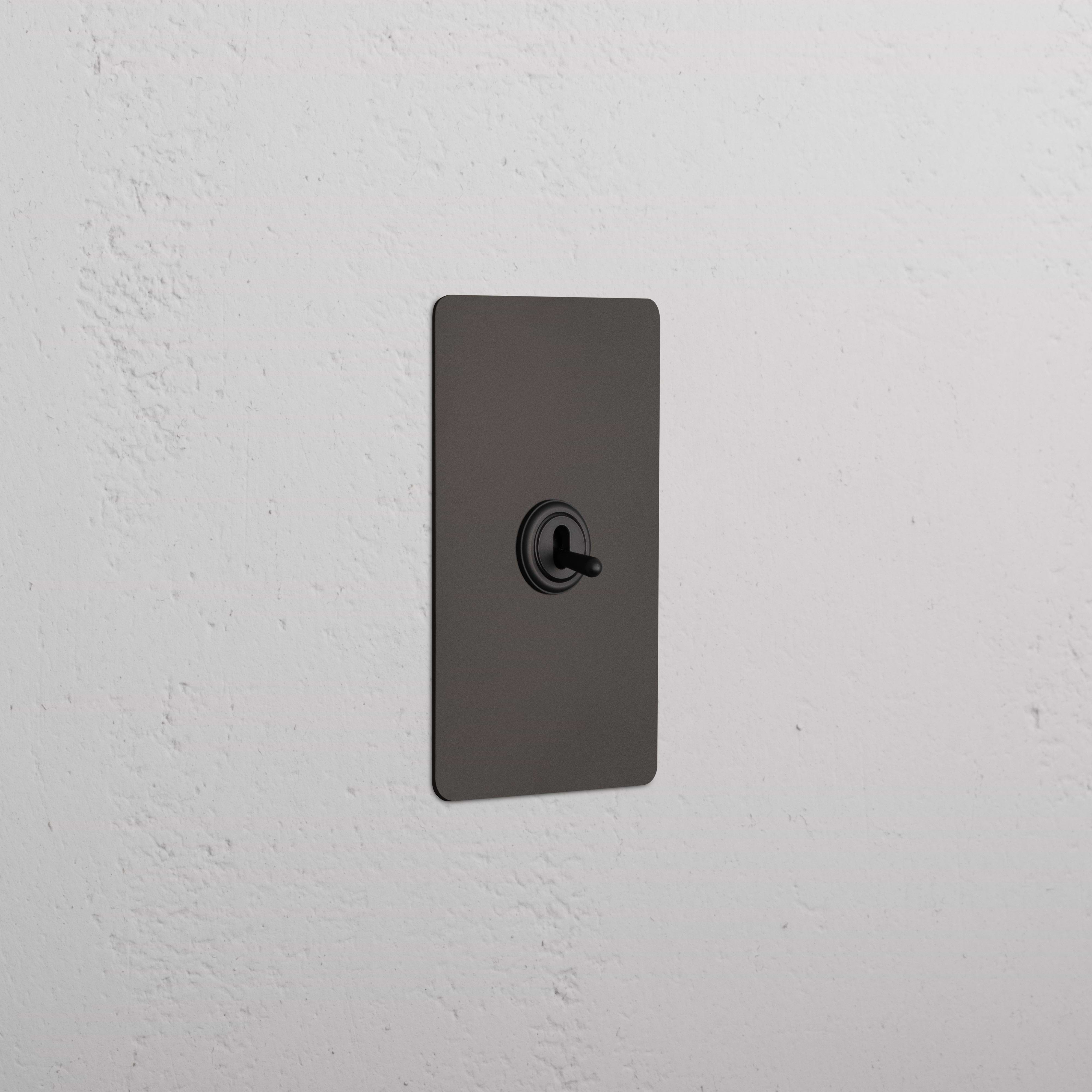 Kew 1G Four Way Toggle Switch in bronze finish, rectangular plate with four toggle switches.