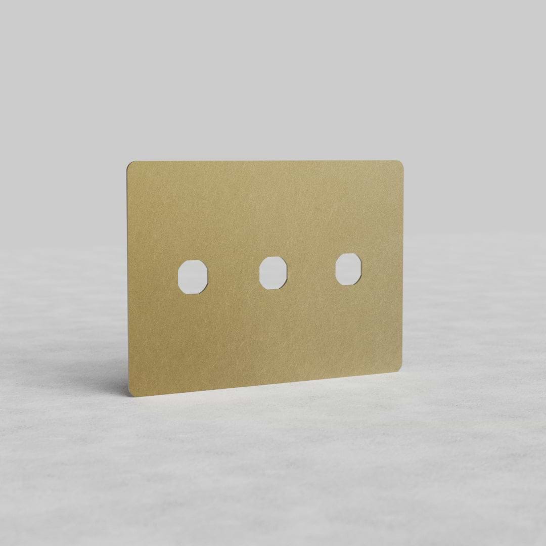 Antique brass 3-gang switch plate (Kew US) with three rectangular switch slots, shown on a white surface.