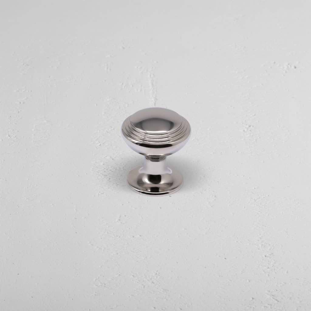 Barlow Furniture Knob Small in polished nickel, round design with grooved top, shown on light surface.