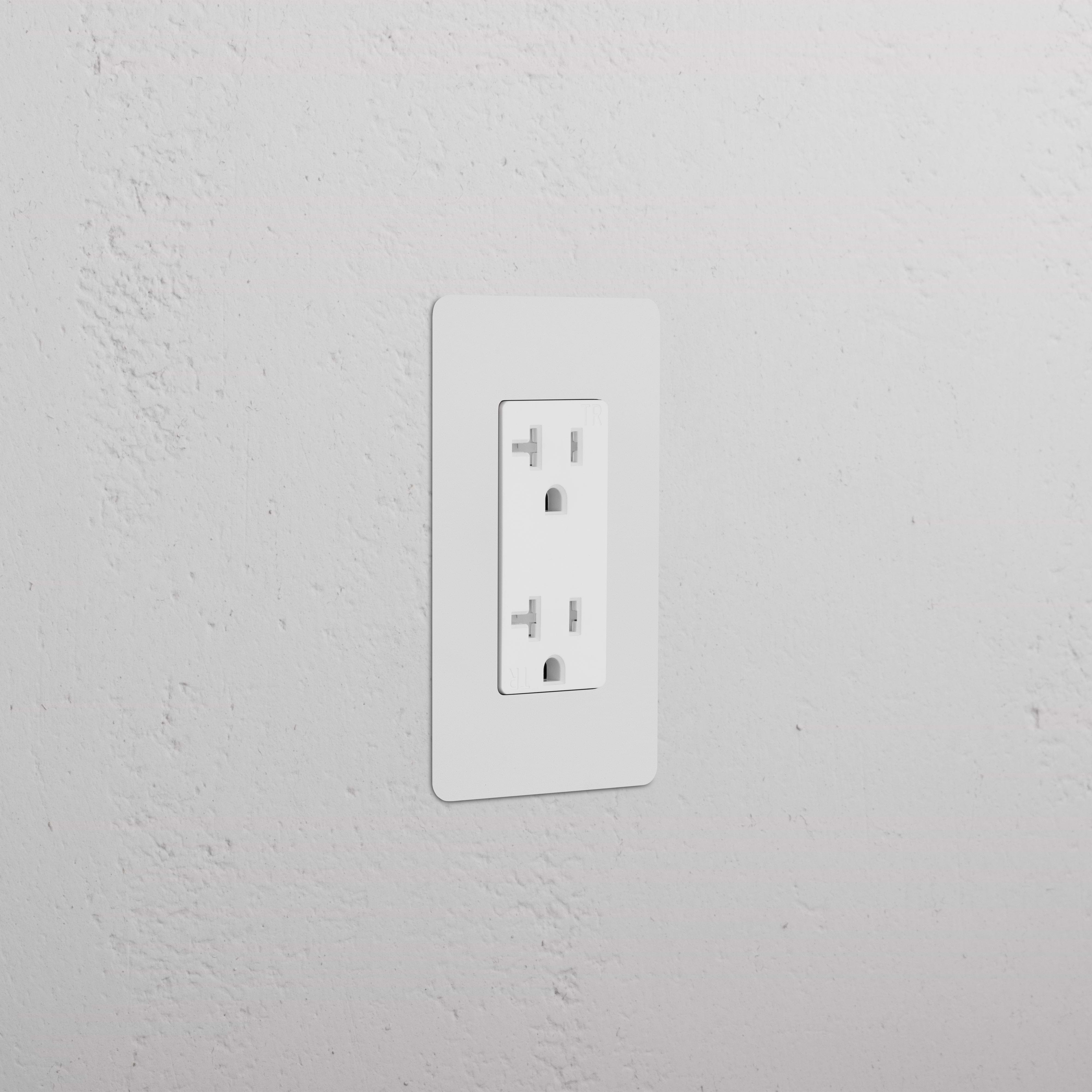 Kew 1G 20A electrical outlet with paintable white rectangular faceplate, installed on a wall.