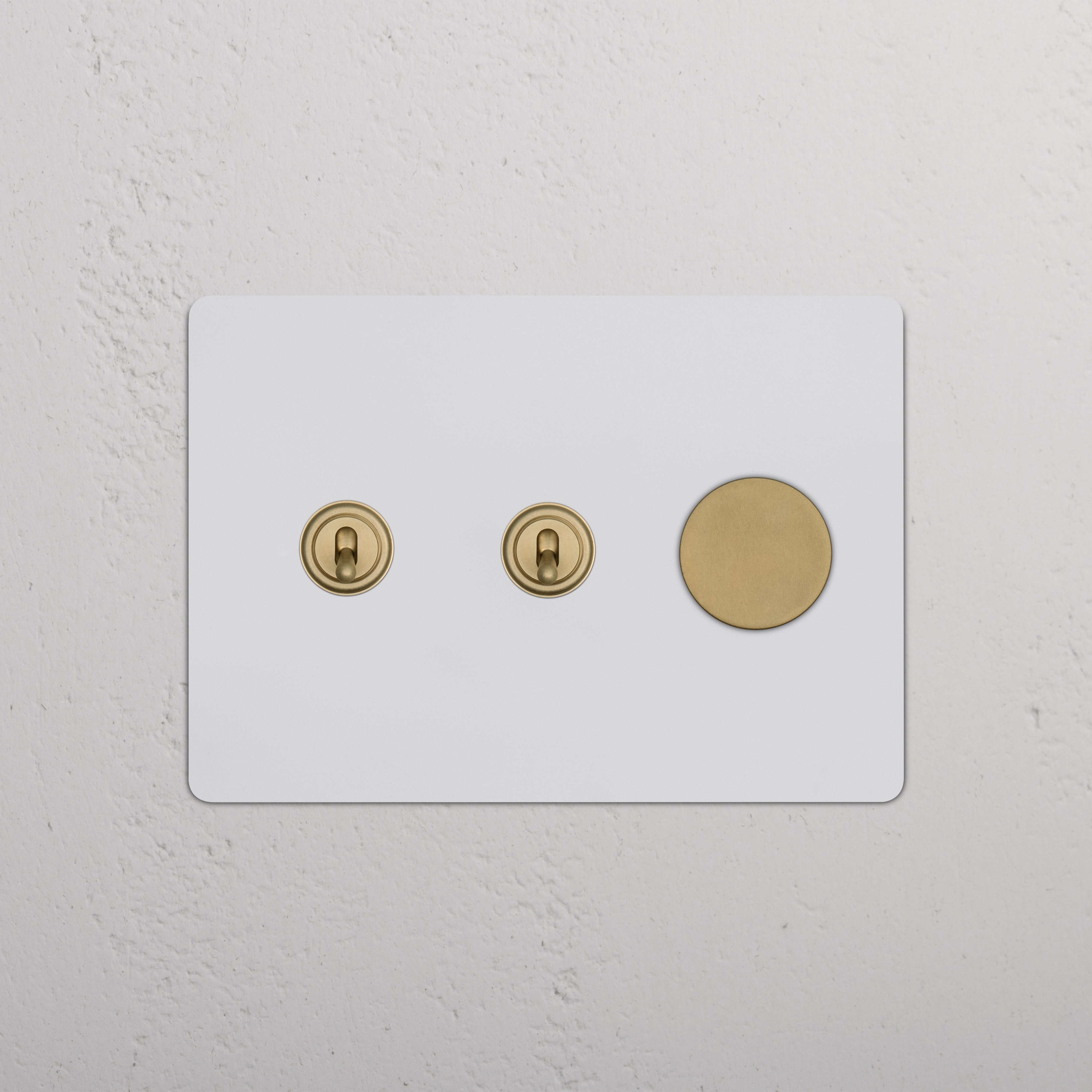 Kew 3G 2x Toggle & Dimmer Switch in paintable antique brass with two toggles and one dimmer button.