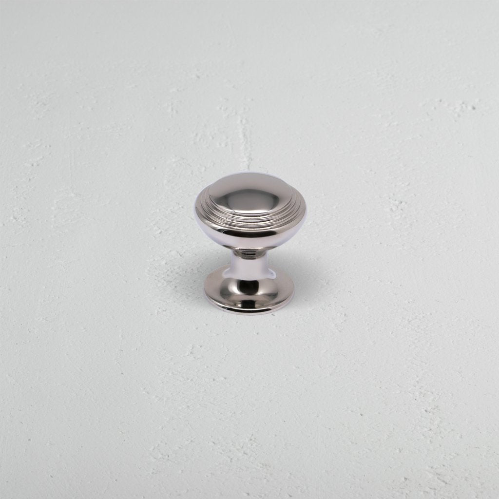Barlow Furniture Knob Small in polished nickel, round design with grooved top, shown on light surface.