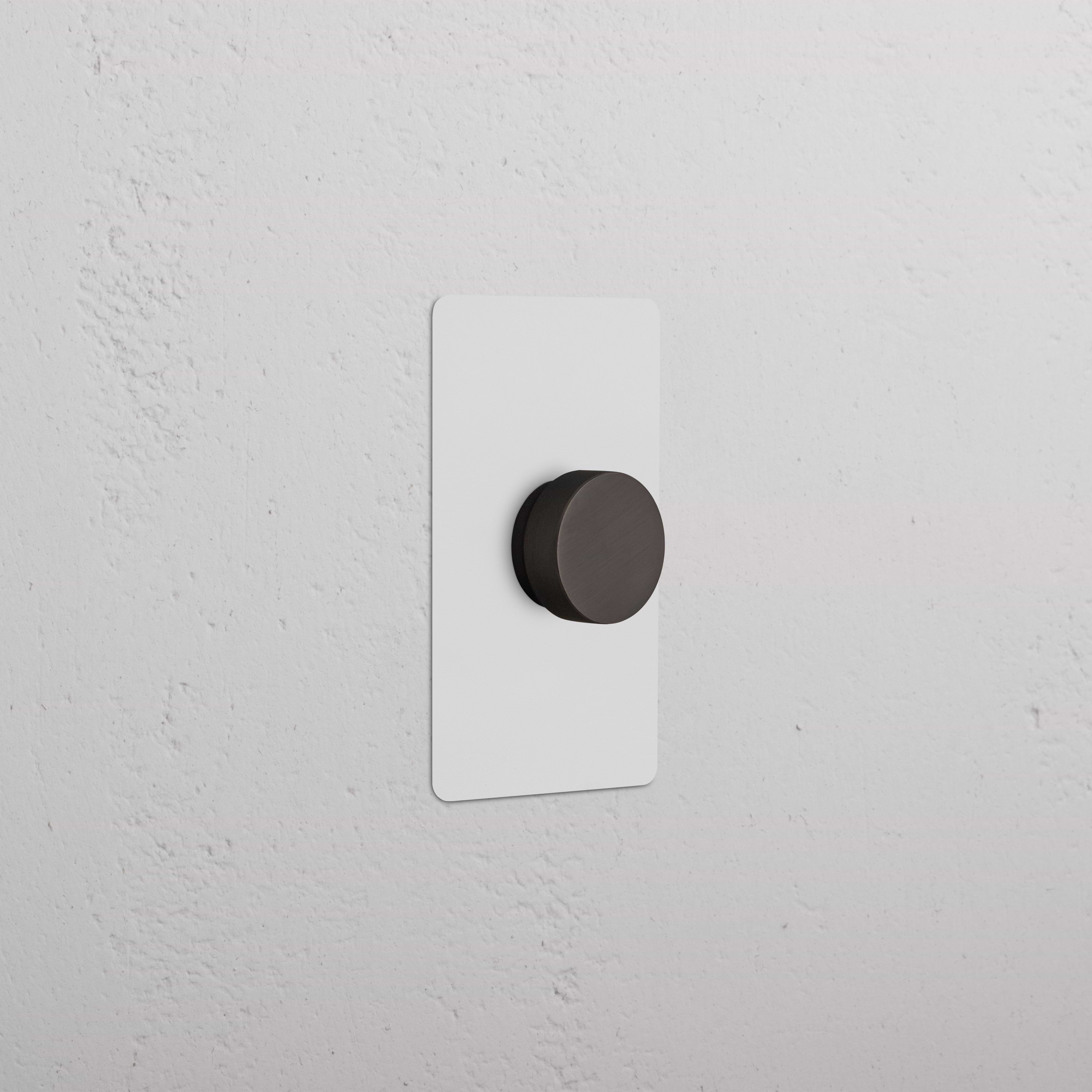 Kew 1G Dimmer Switch in paintable bronze finish with round knob on a rectangular wall plate.
