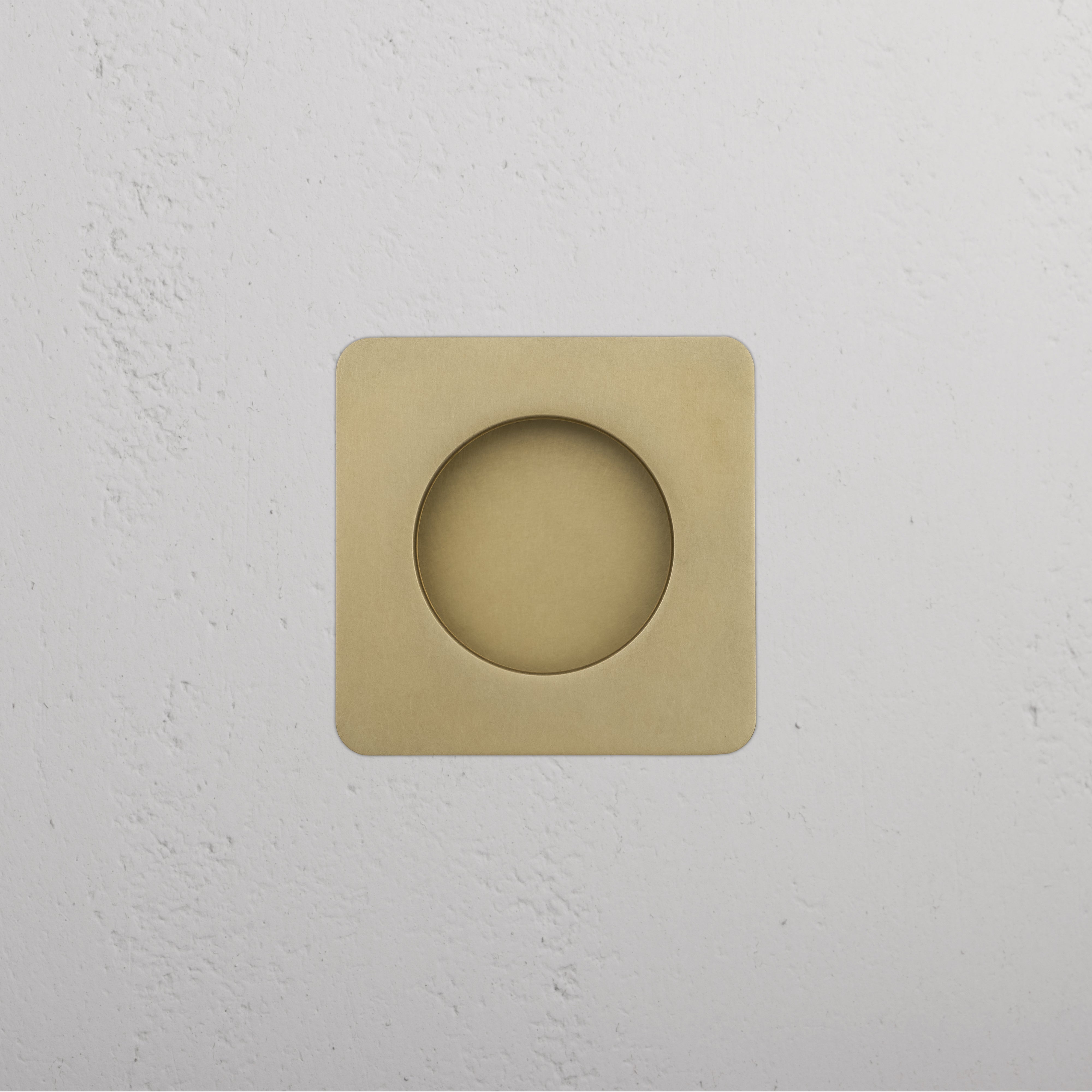 Regent Recessed Small Pull in Antique Brass, square design with center cutout, mounted on white wall.