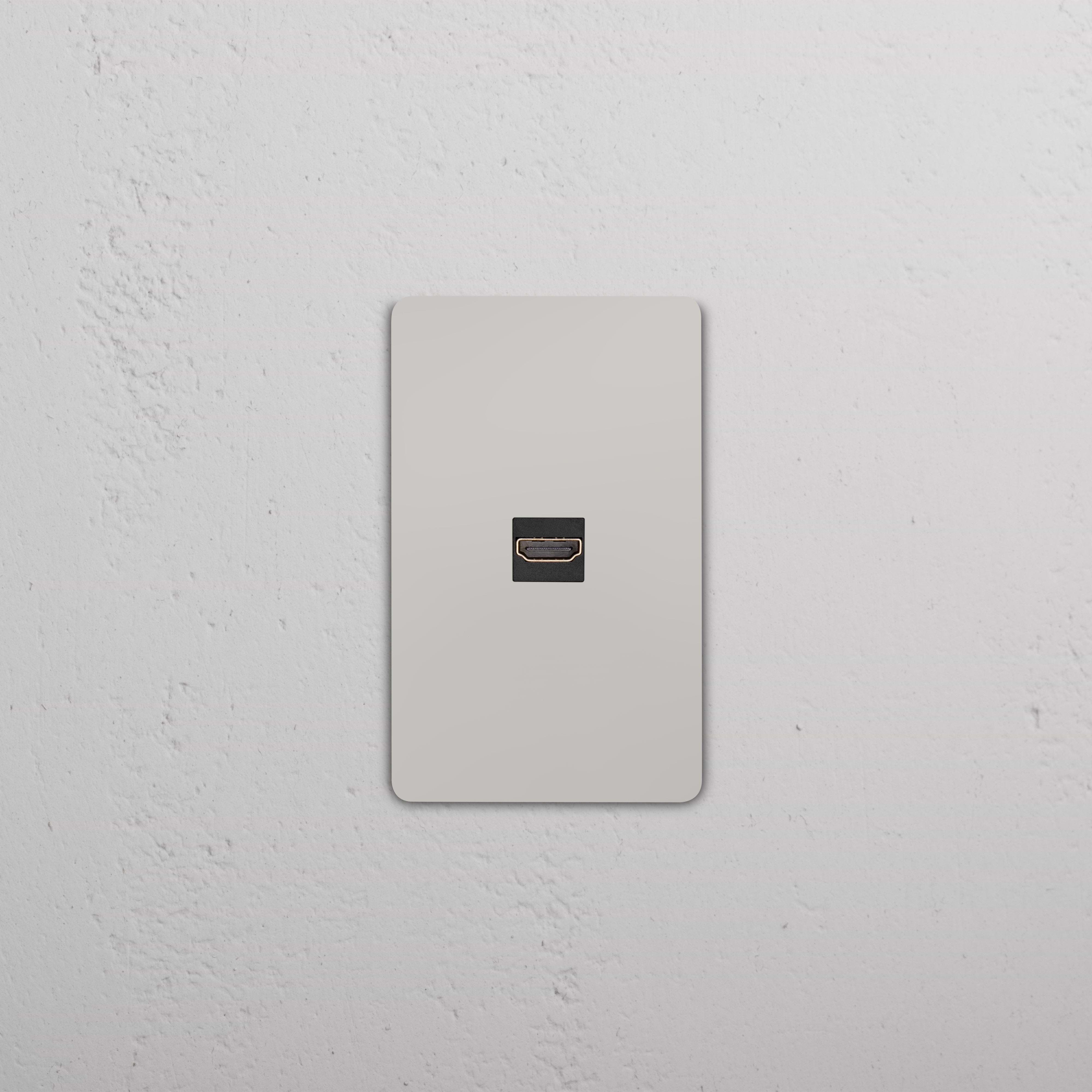 Grove 1G HDMI Keystone wall plate in polished nickel with black HDMI port, shown mounted on a wall.
