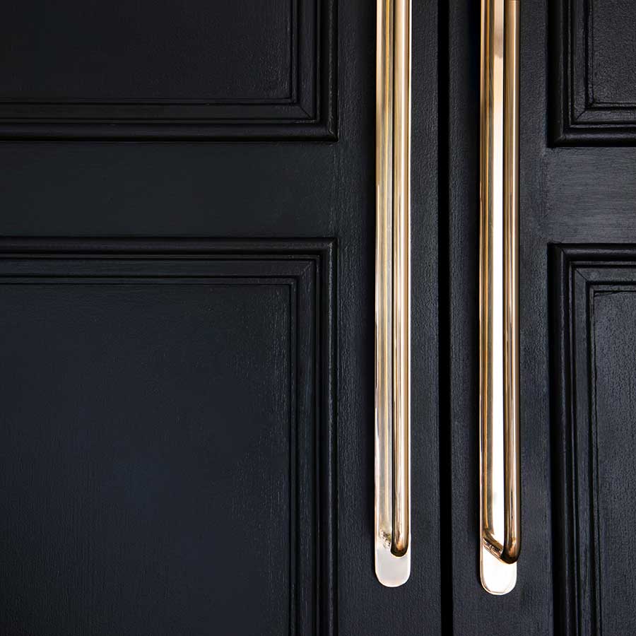 Kilburn Furniture Handle Large in Antique Brass, mounted on a door, featuring a modern, elegant design.