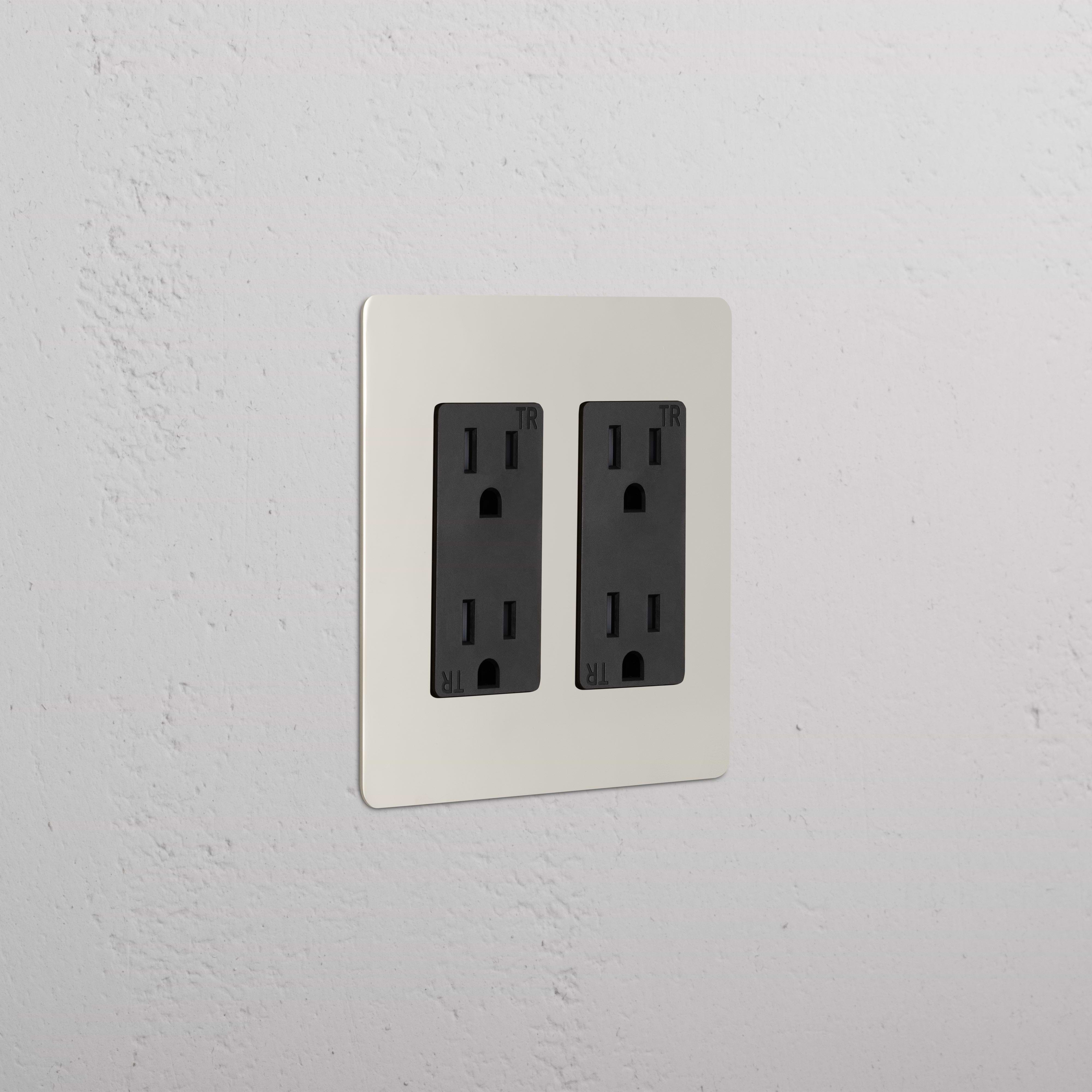 Kew 2G Outlet in polished nickel black finish with two black tamper-resistant three-prong sockets.