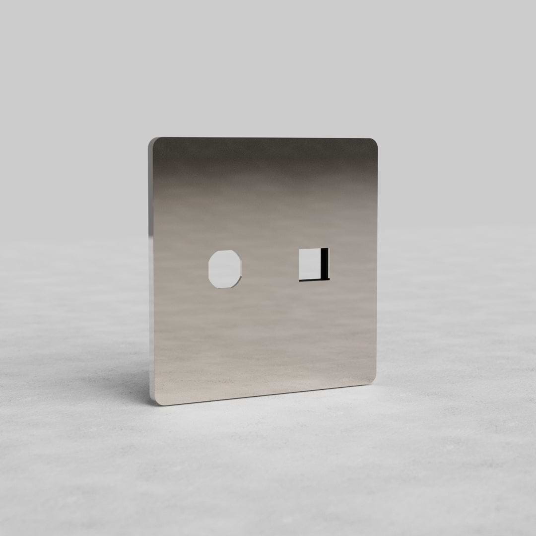 Polished nickel 2G Switch & Keystone Plate Grove US with hexagonal and rectangular openings on gray surface.