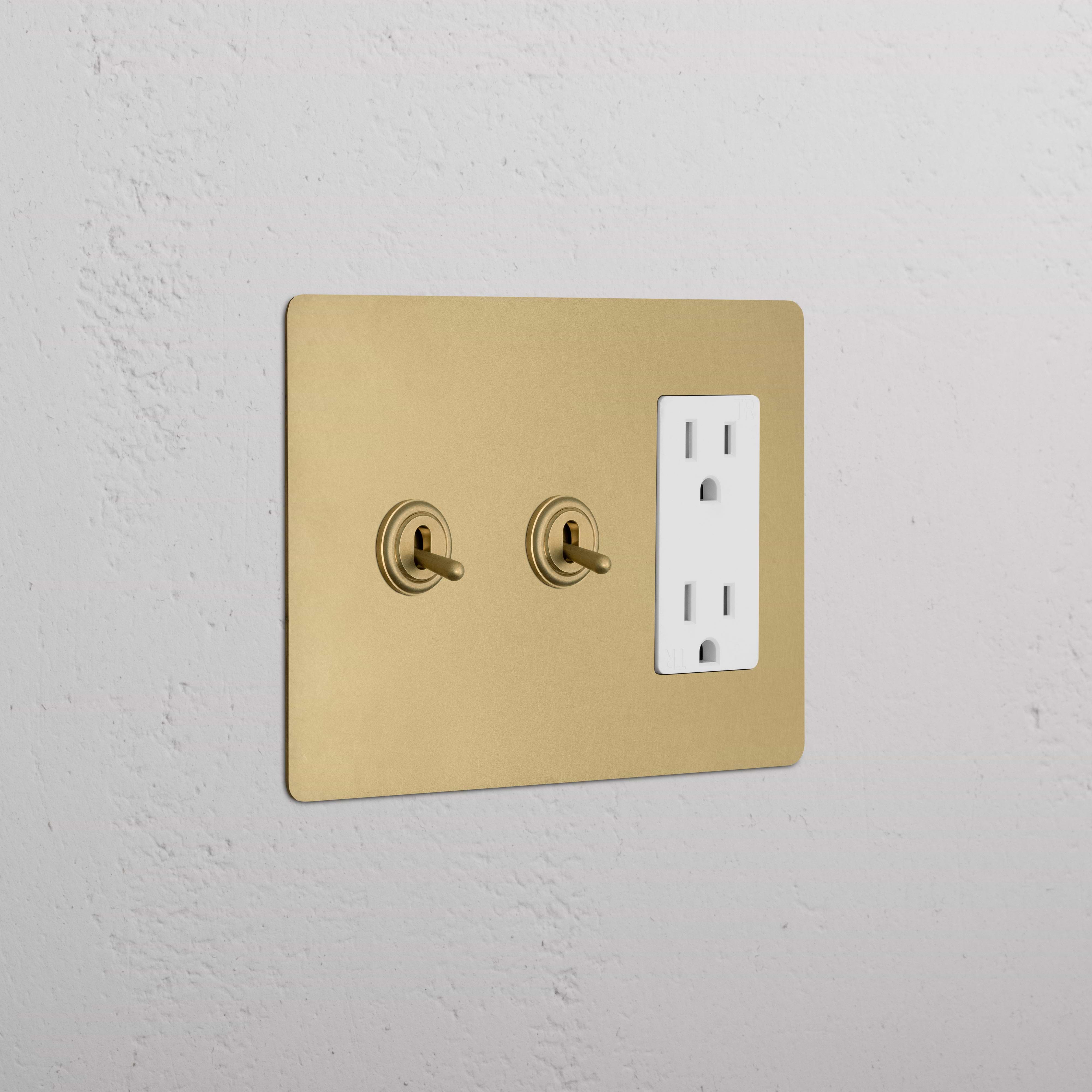Kew 3G 2x Toggle Switch & Outlet in antique brass with white finish, featuring two toggles and a power outlet.
