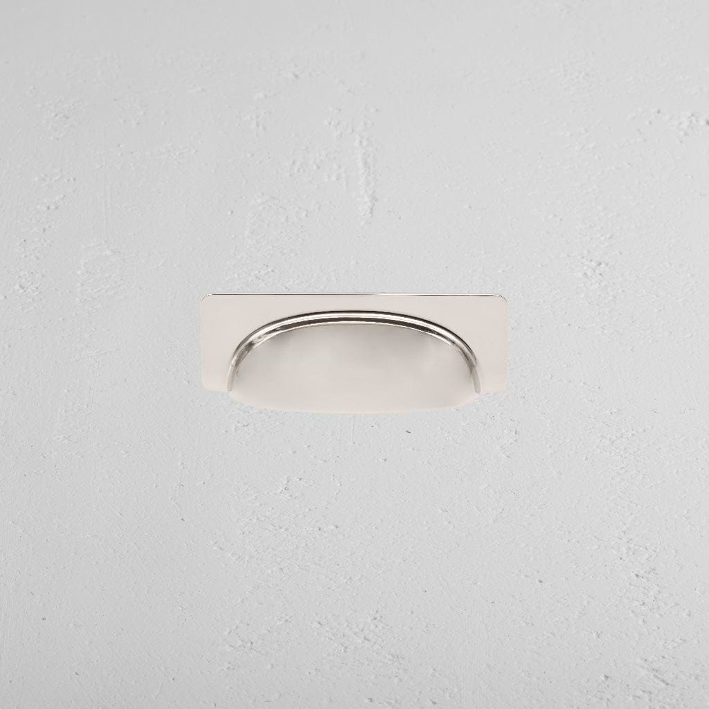 Elm Cup Handle Small in polished nickel finish, mounted horizontally on a light gray textured surface.