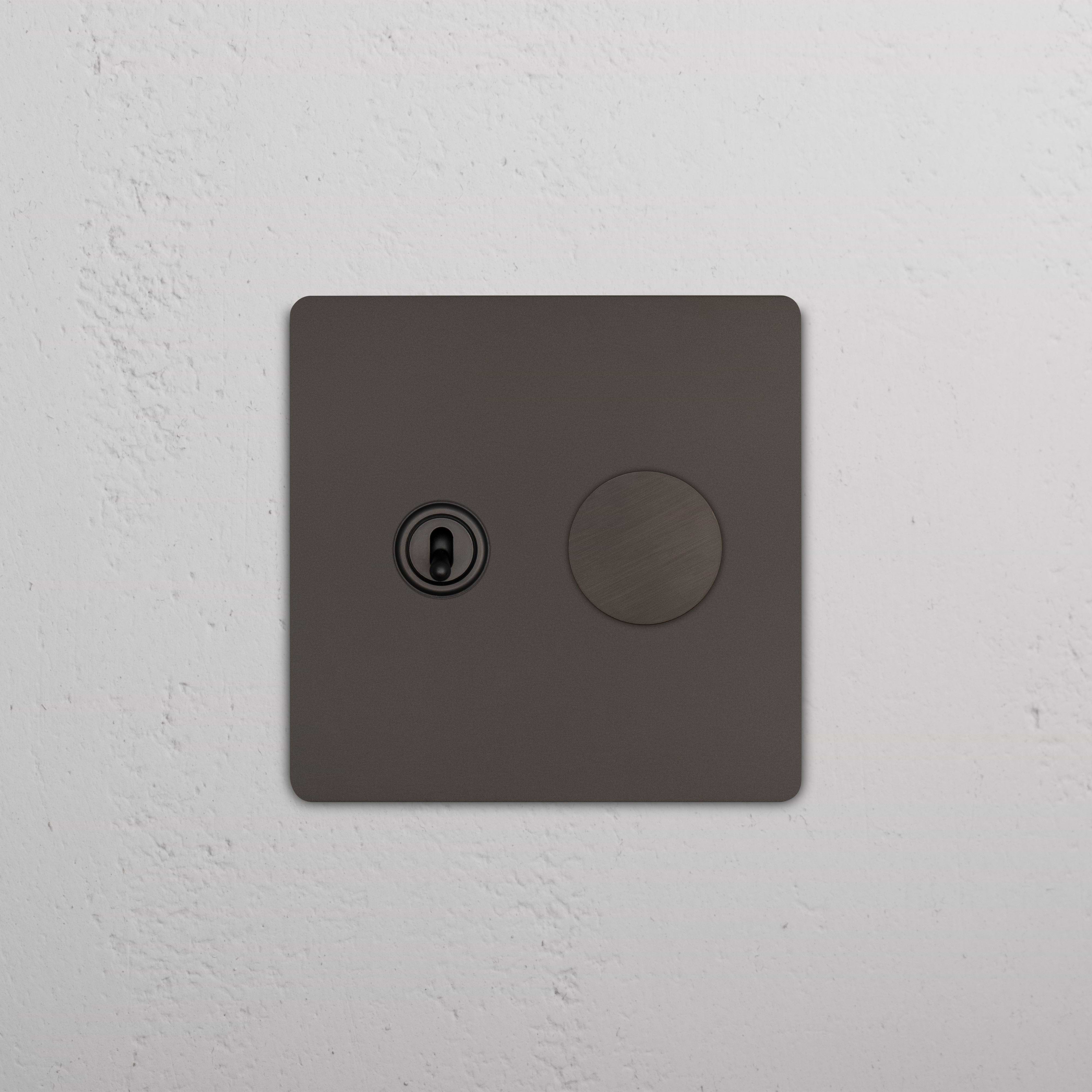 Bronze Grove 2G Toggle & Dimmer Switch with one toggle and one dimmer, shown mounted on a white wall.