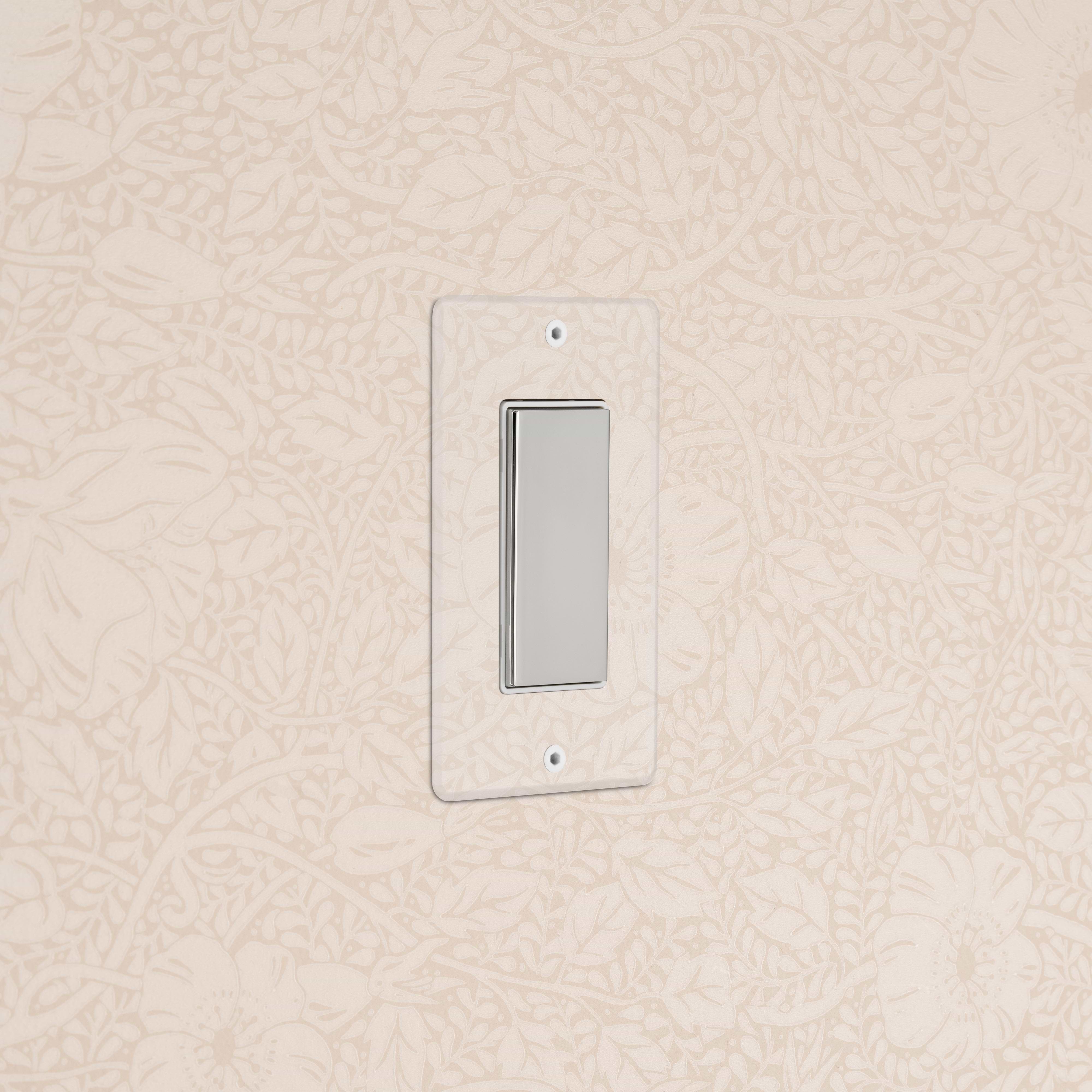 Kew 1G Center Retractive Rocker Switch in clear polished nickel white with a clear rectangular faceplate on wall.