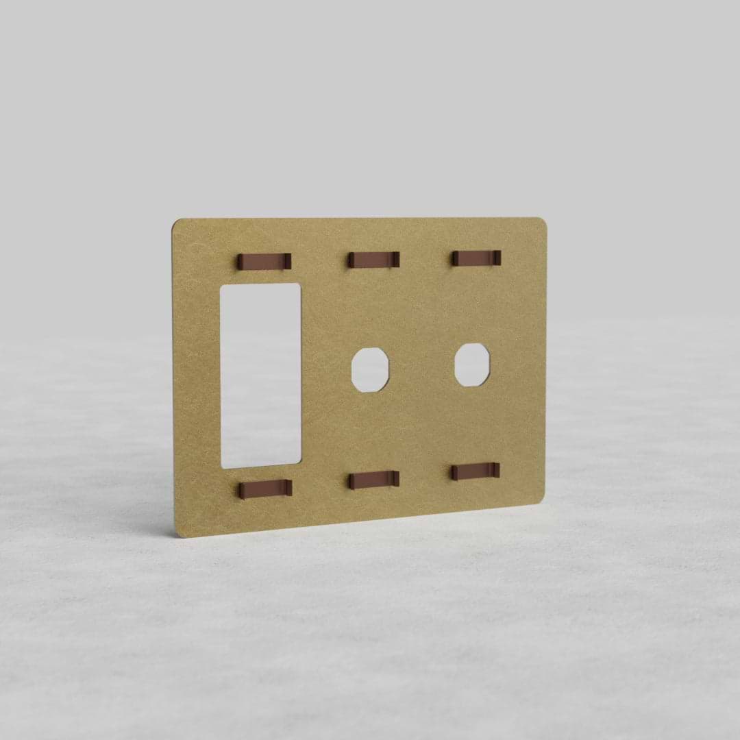 Antique Brass 3G 2x Switch & Outlet Plate Kew US, rectangular with switch and outlet cutouts, on gray surface.