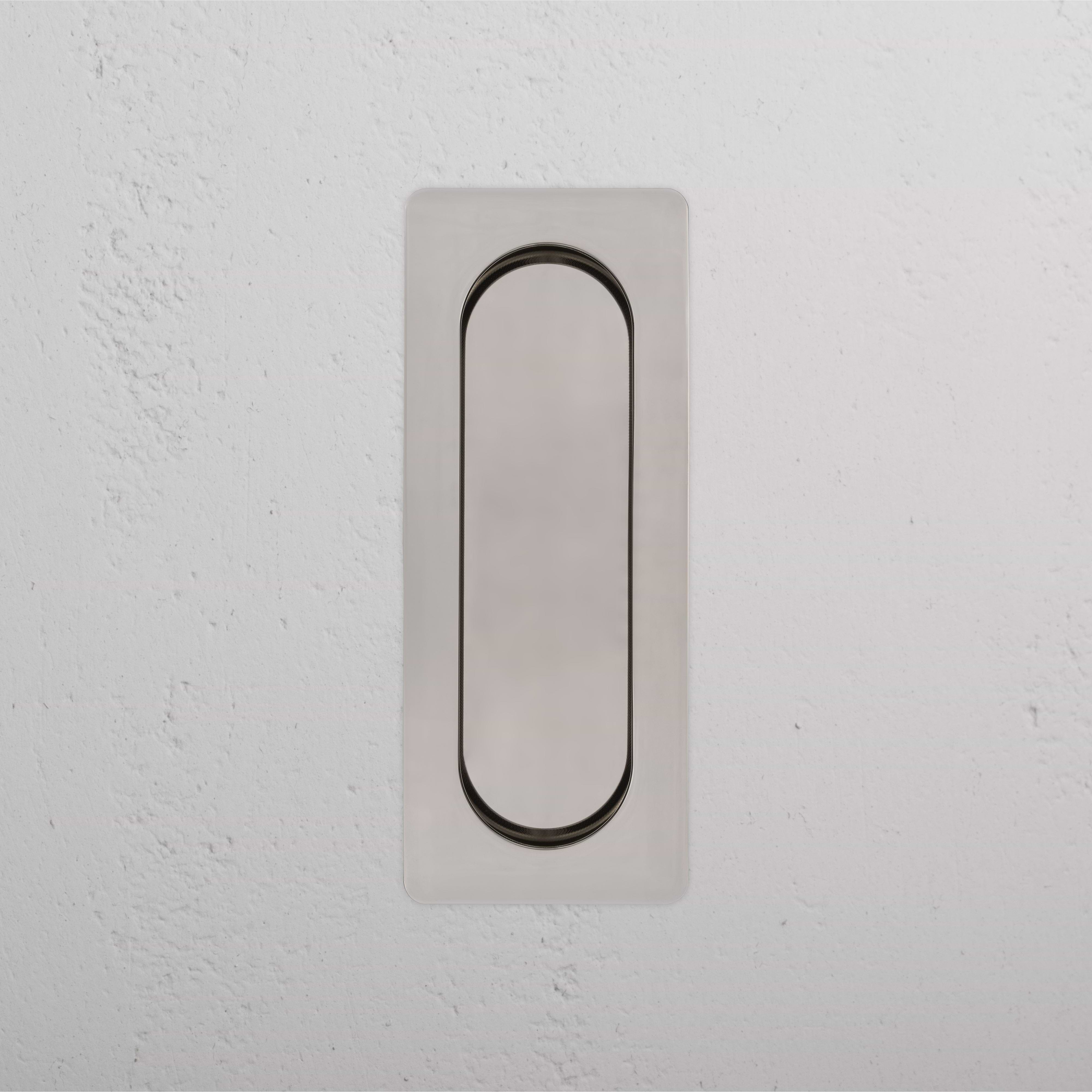 Regent Recessed Medium Pull in polished nickel, rectangular design, mounted on a white textured wall.