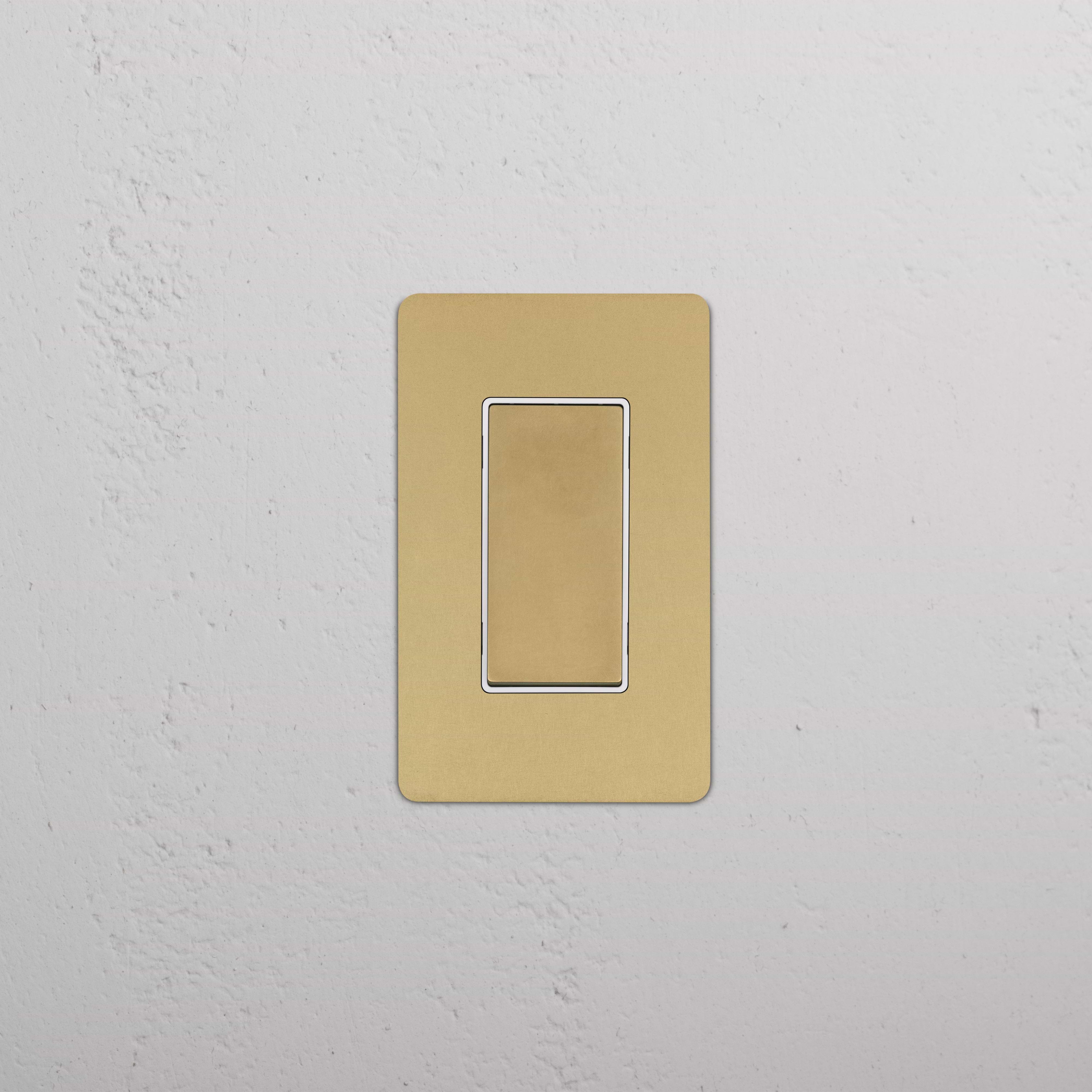 Kew 1G Four Way Rocker Switch in antique brass with white trim, mounted on a wall.