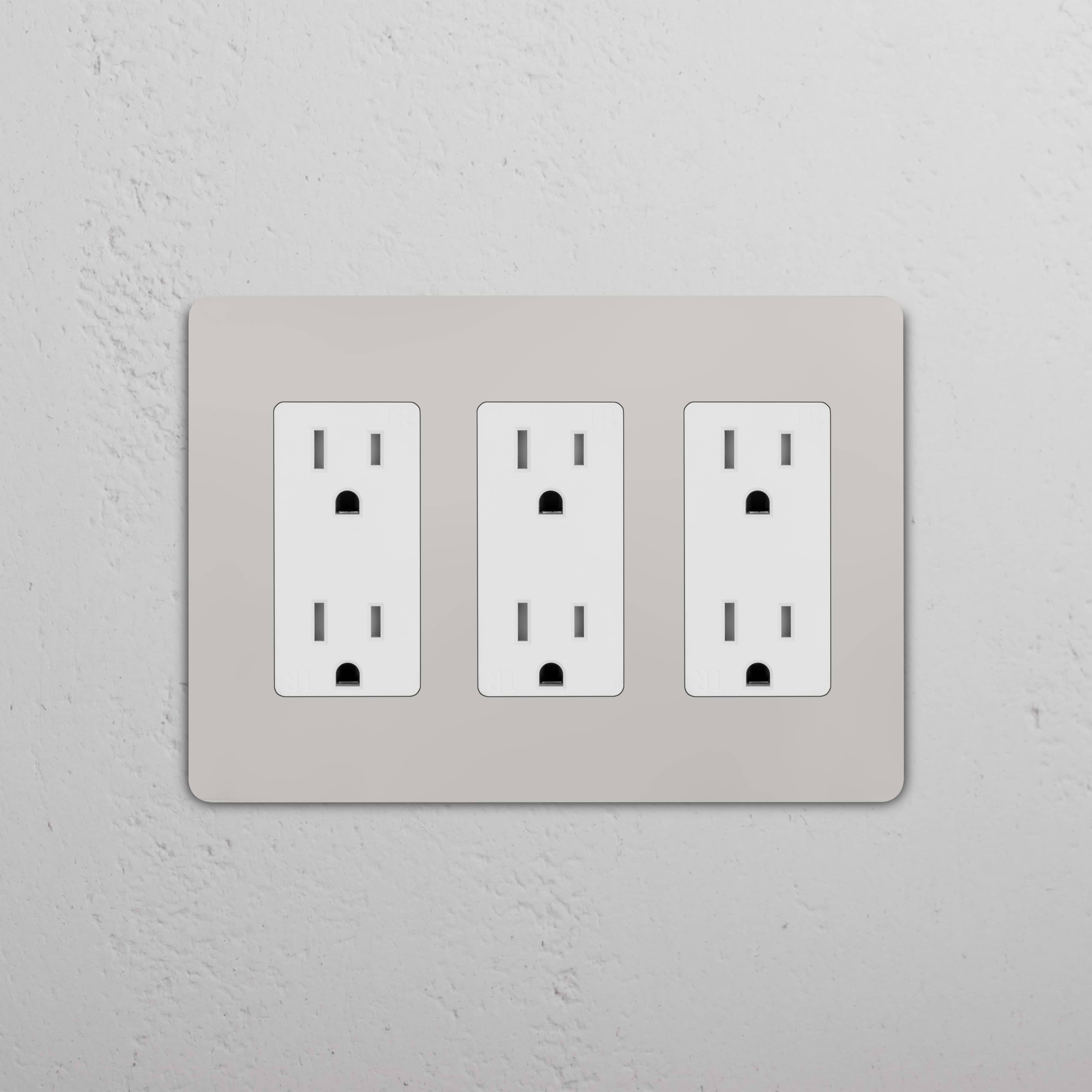 Grove 3G Outlet in Polished Nickel White with three standard power outlets, shown mounted on a white wall.