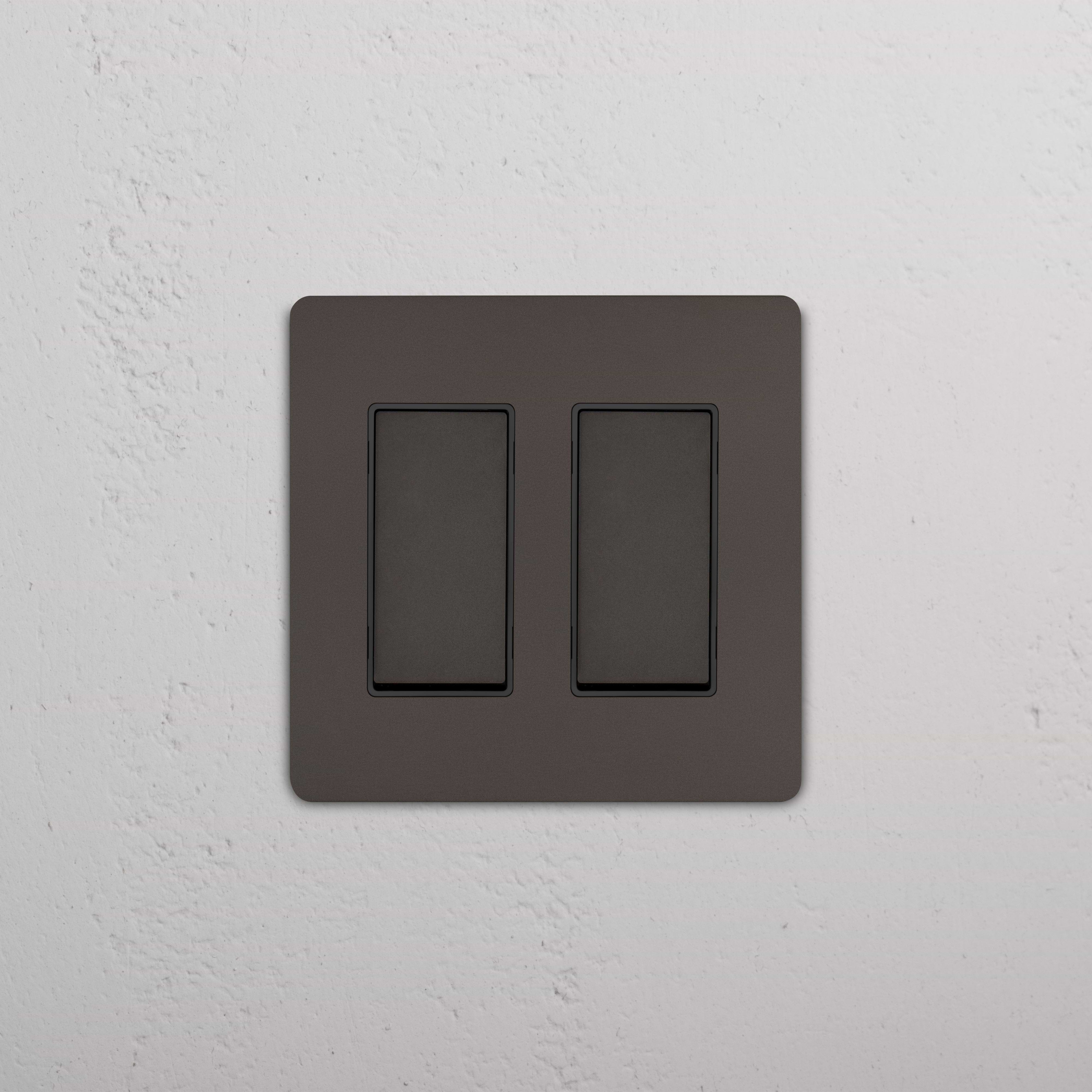 Grove 2G Rocker Switch in Bronze Black with two rectangular switches on a matching black plate.