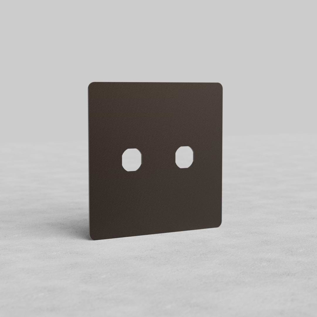 Bronze 2G Switch Plate Kew US with two switch apertures, shown on a light, textured surface.