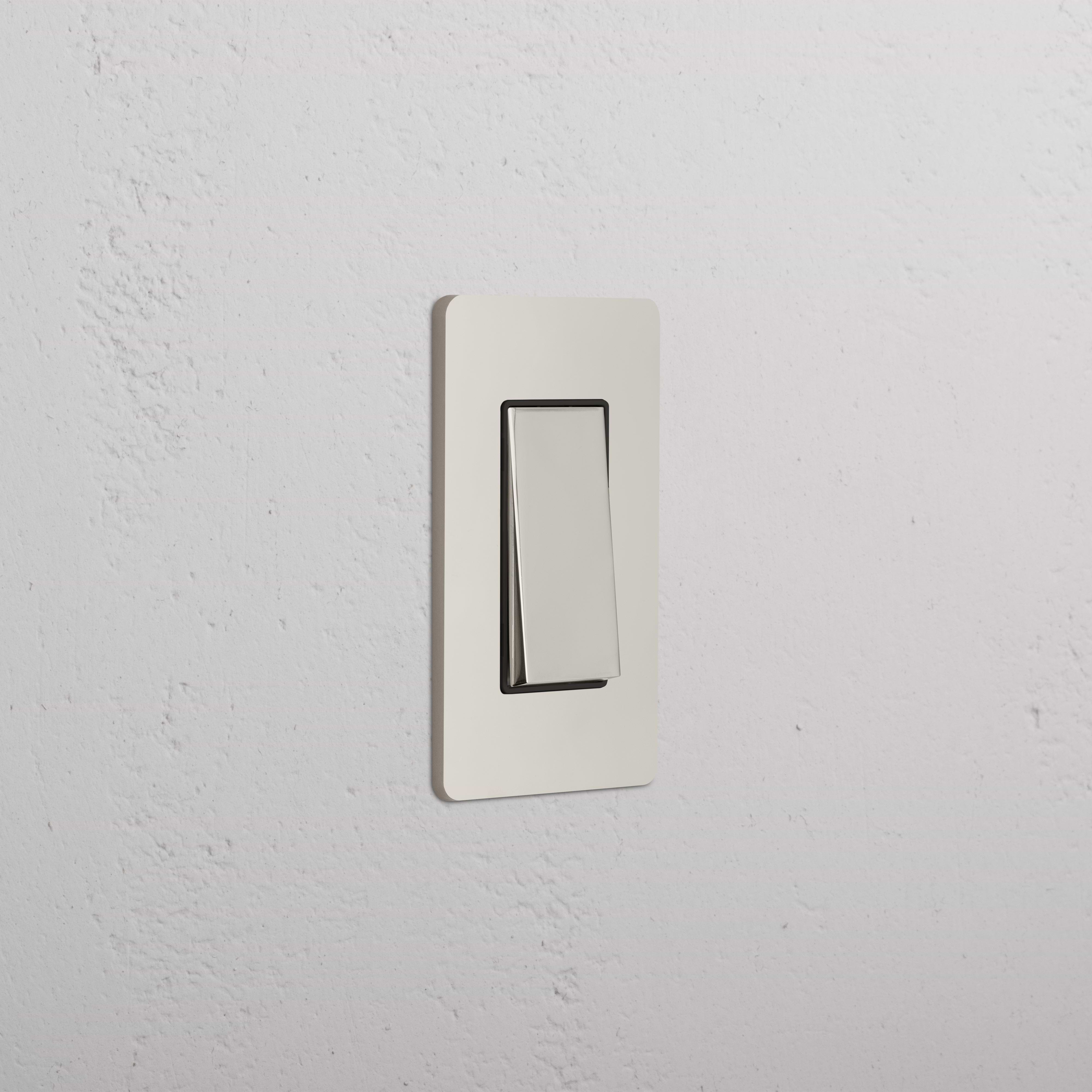 Grove 1G Retractive Rocker Switch in polished nickel black, mounted on a white textured wall, in off position.