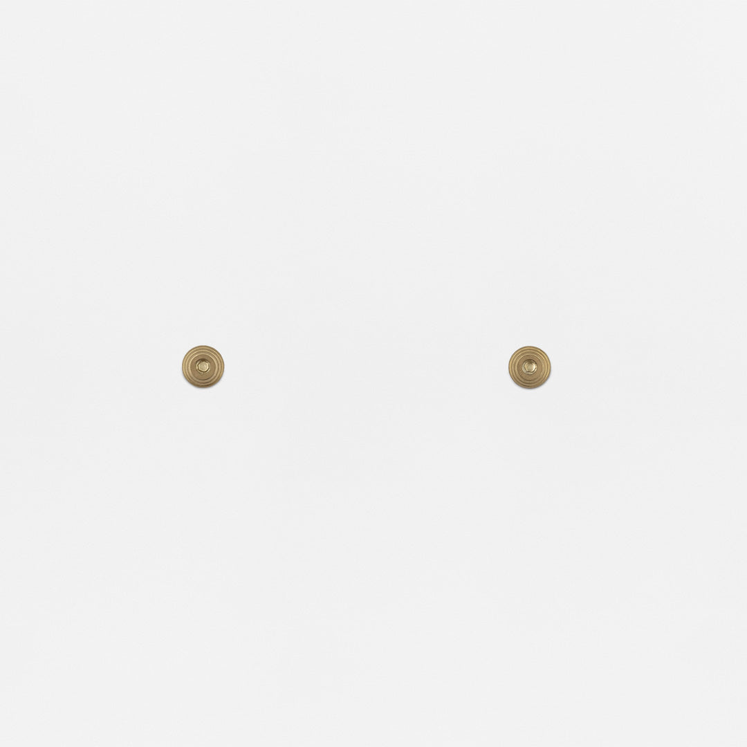 Pair of Belmont Hung Window Stops in Antique Brass finish, mounted on a plain white surface.