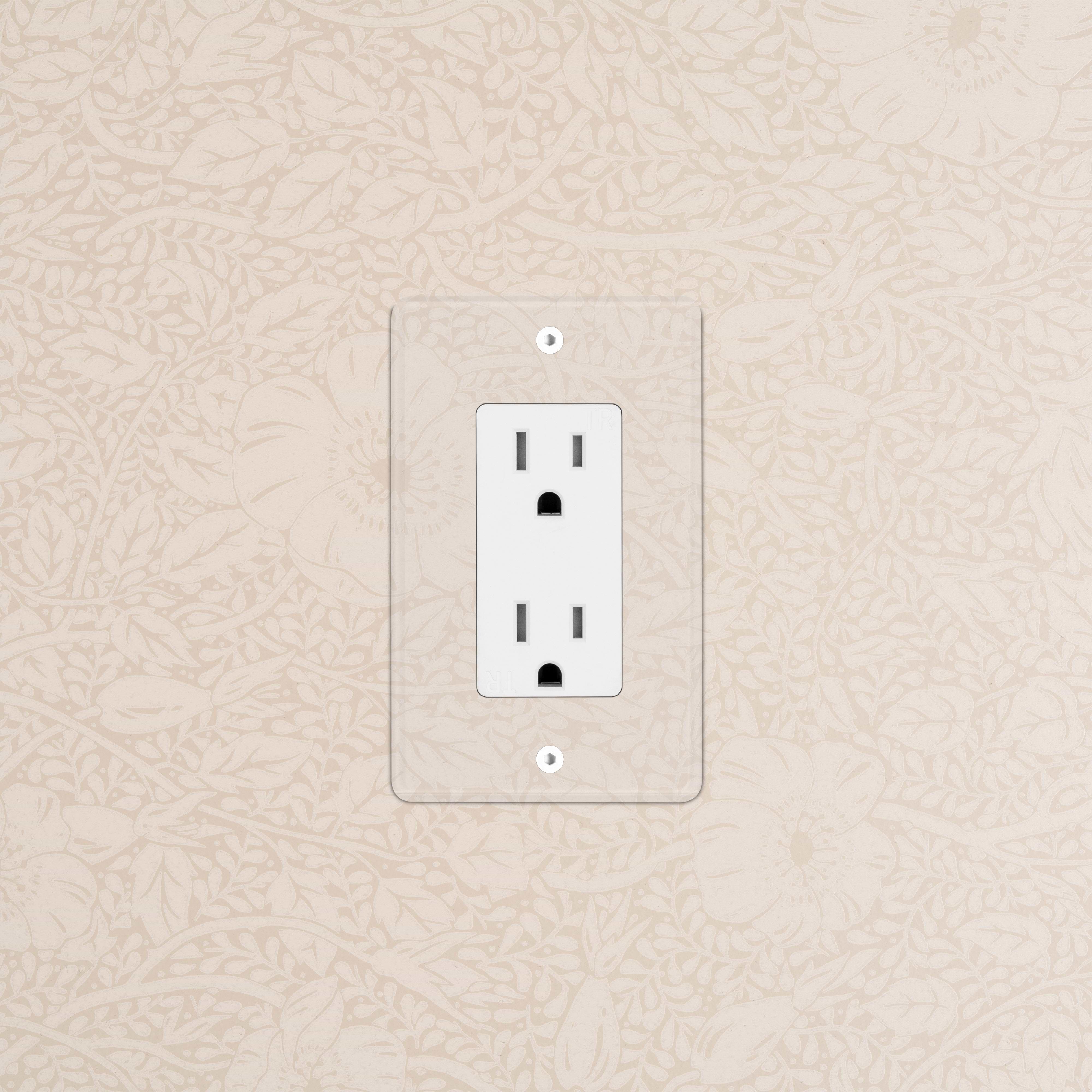 Kew 1G 15A Outlet in clear white, single socket, mounted on a beige wall with subtle floral pattern.