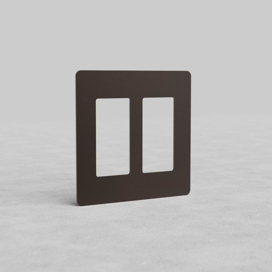 Bronze 2G Outlet Plate Kew US with two rectangular cutouts, shown upright on a light gray surface.