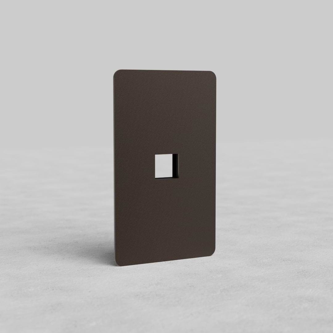 Bronze 1G Keystone Plate Kew US with single keystone cutout, displayed upright on a light gray surface.