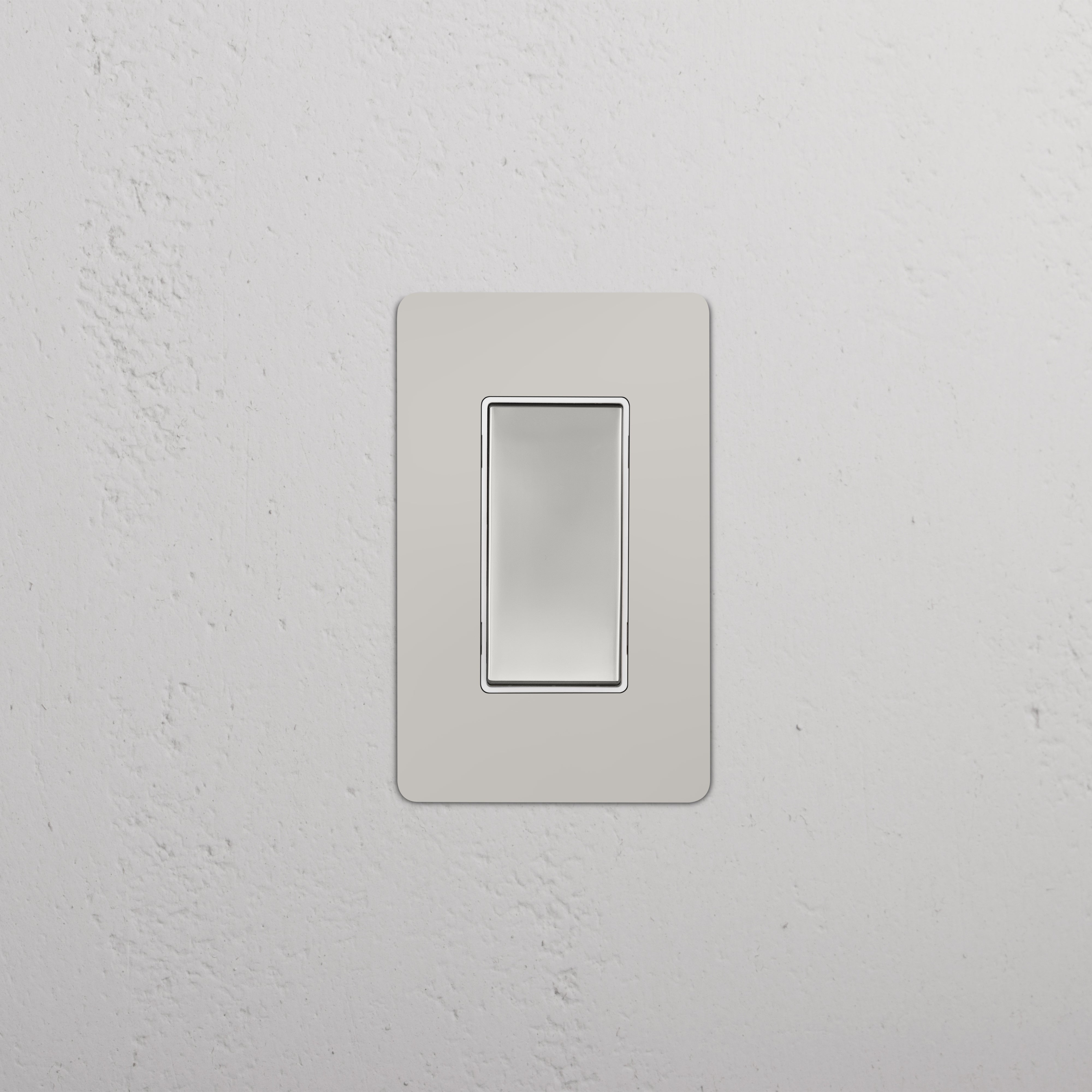 Kew 1G Retractive Rocker Switch in polished nickel white with flat modern design, shown installed on a wall.