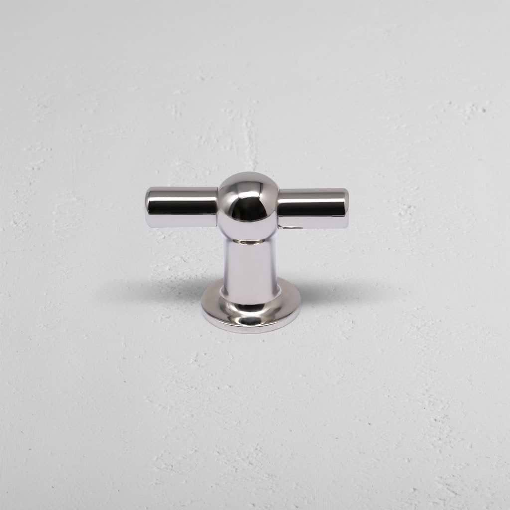 Harper T-Bar Furniture Handle Medium in polished nickel, T-shaped with round base, on light gray surface.