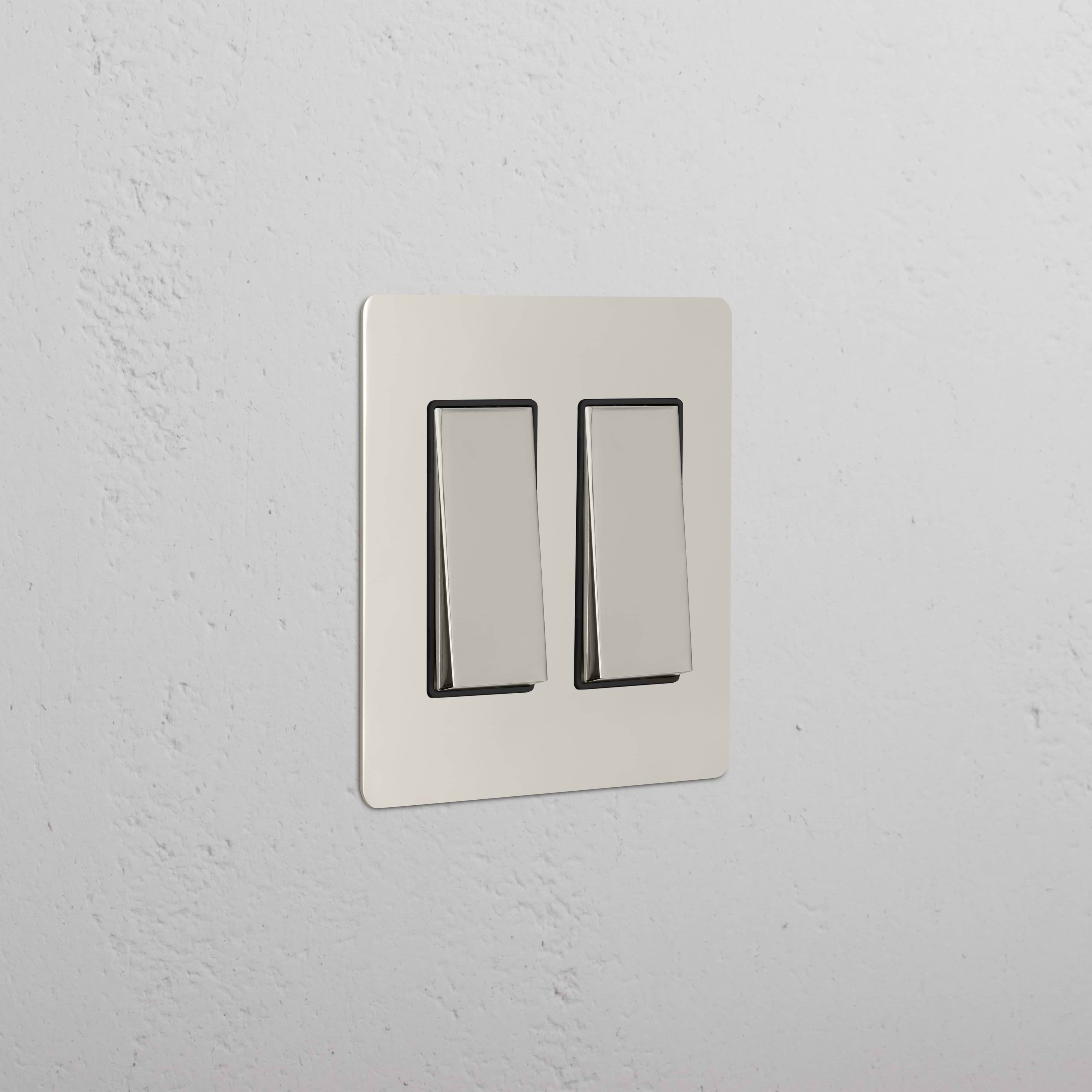 Kew 2G Rocker Switch in Polished Nickel Black with a sleek metallic finish, mounted on a wall.