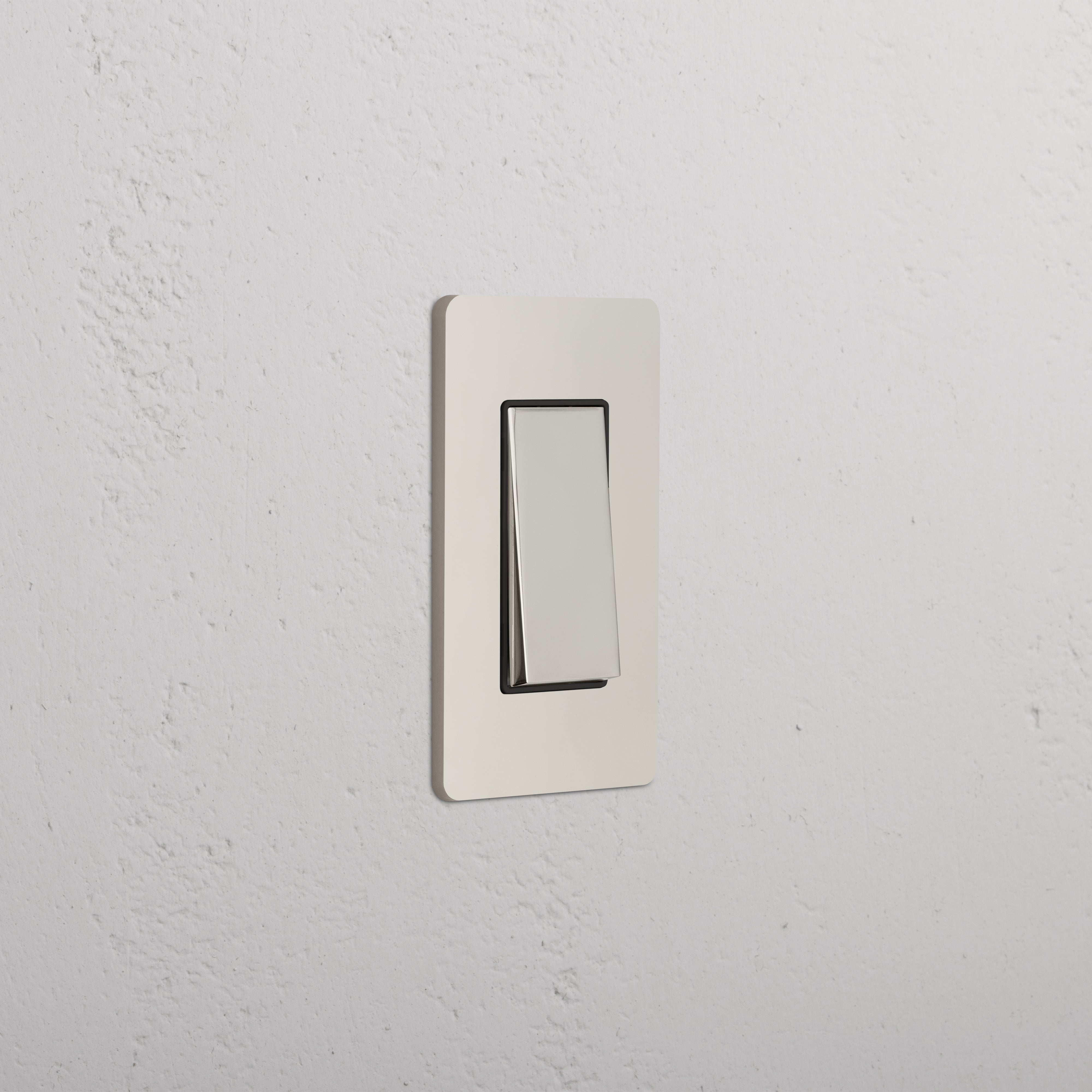 Grove 1G Rocker Switch in Polished Nickel Black, rectangular, mounted on a white wall.