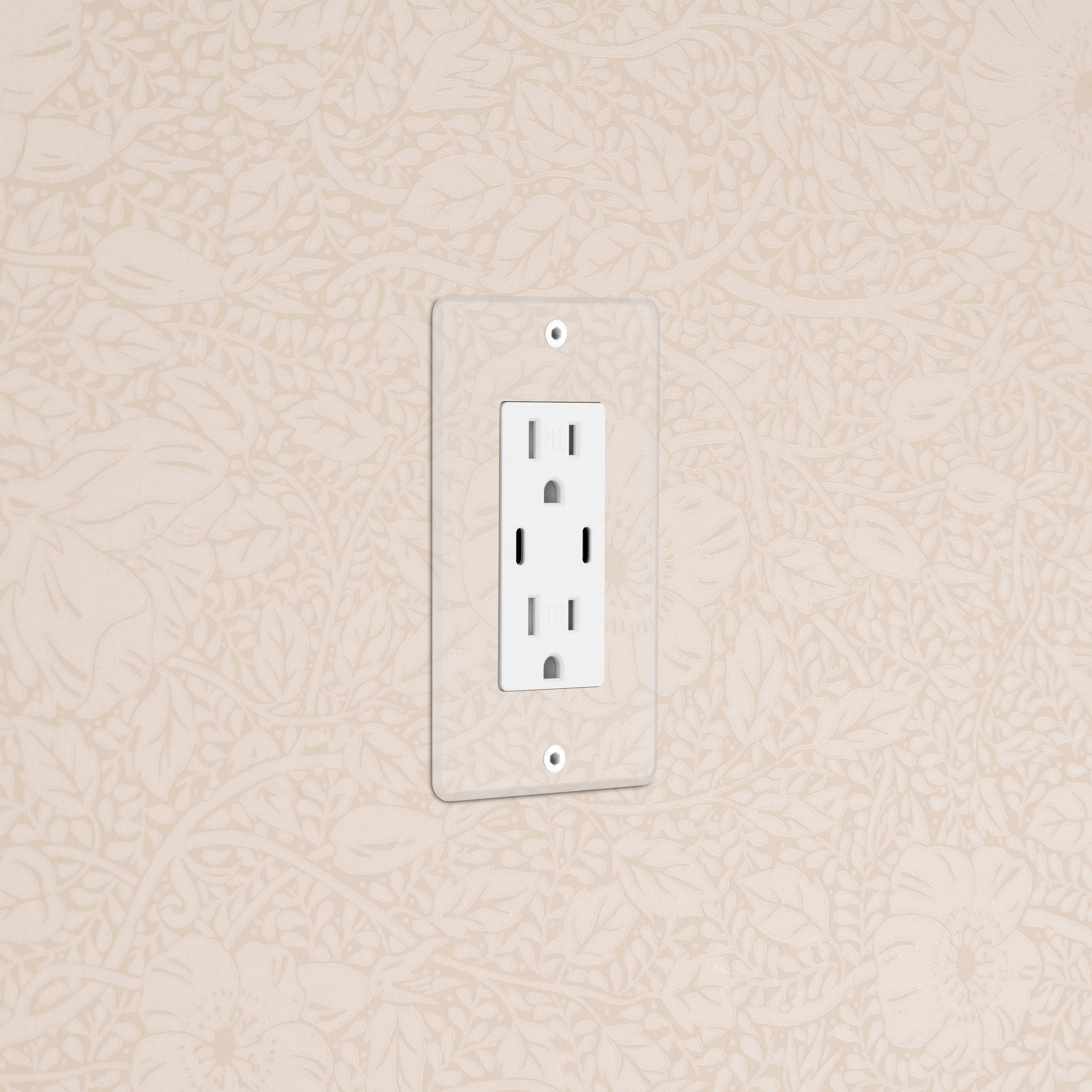 Kew 1G 15A USB Outlet in Clear White with two sockets, mounted on a beige patterned wall.