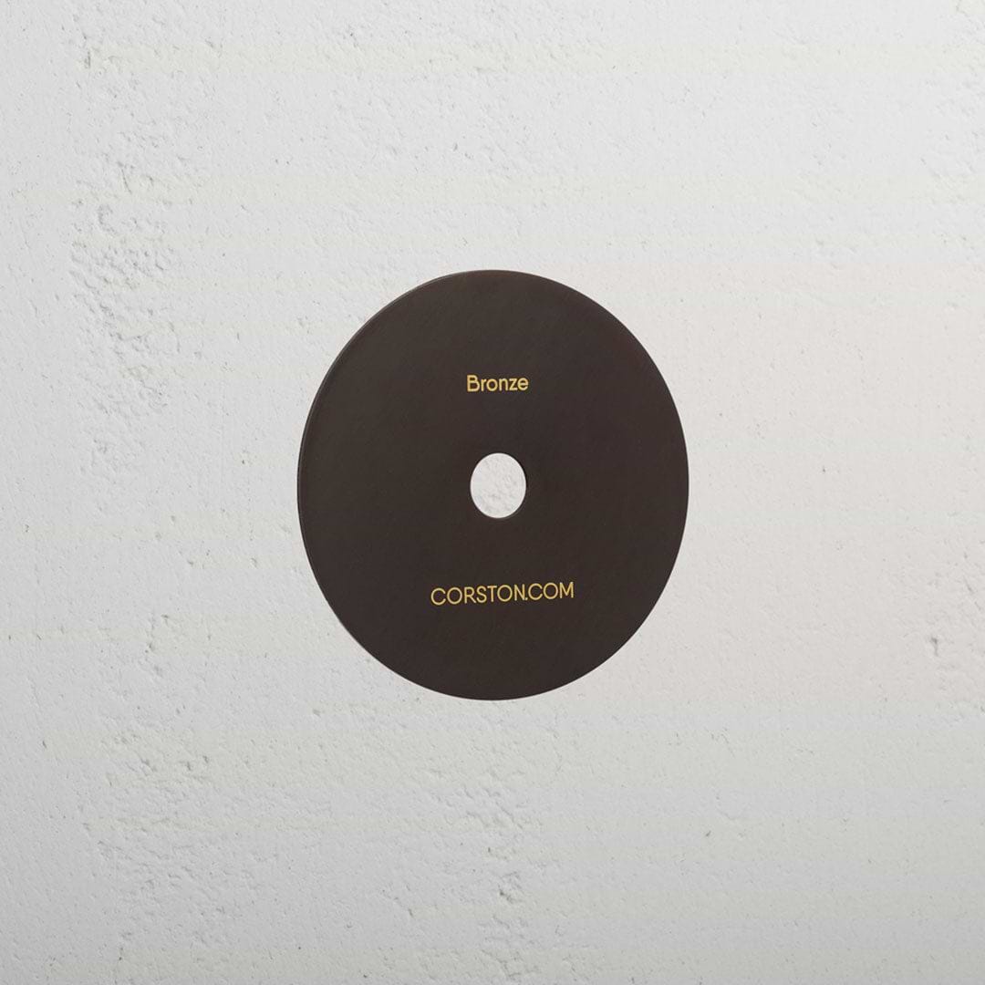 Bronze Sample Finish disc with 'Bronze' and 'CORSTONCOM' text, displayed on a white textured surface.
