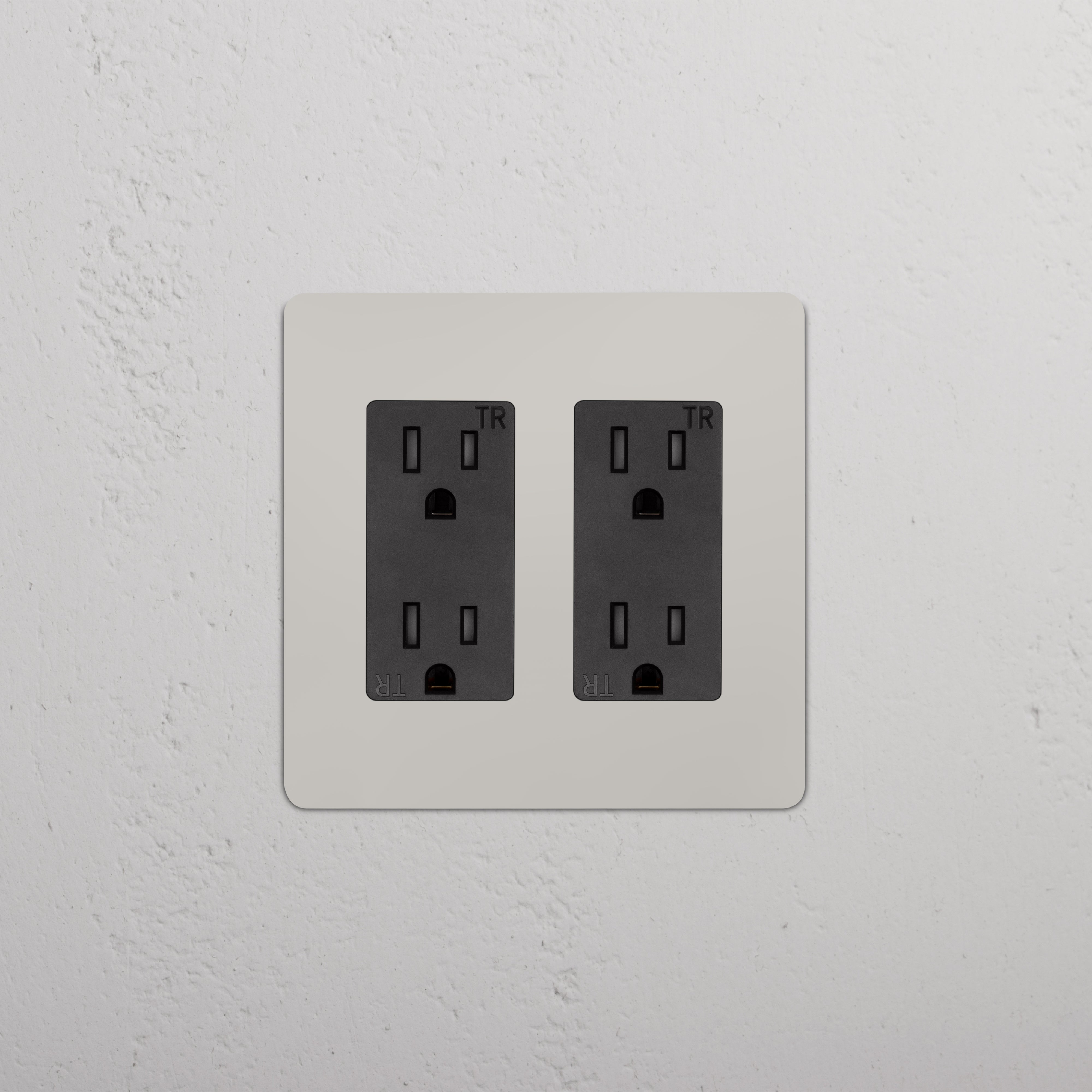 Kew 2G Outlet in polished nickel with black two-gang sockets, wall-mounted on a textured surface.