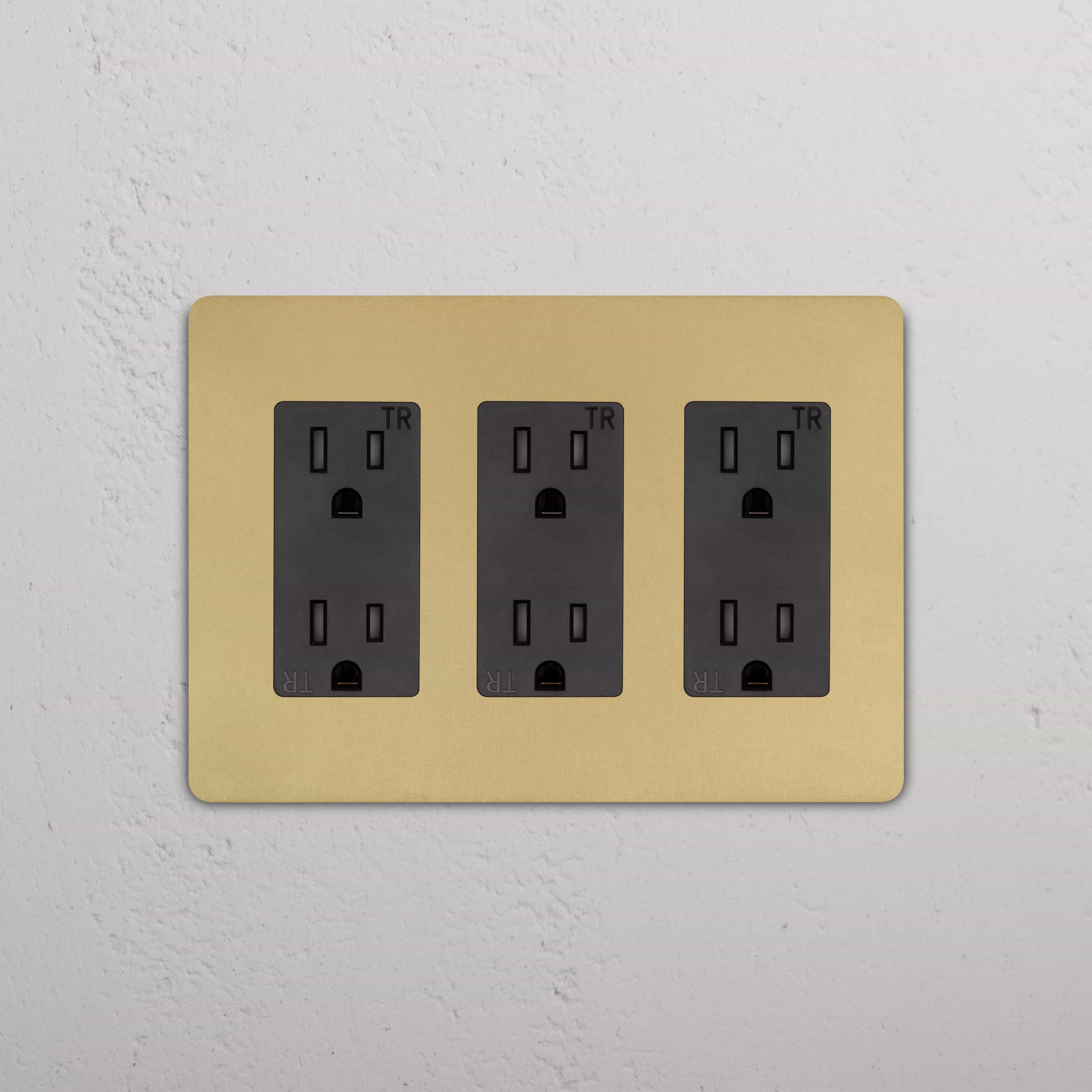Grove 3G Outlet in antique brass black finish, triple electrical socket on a light textured white wall.