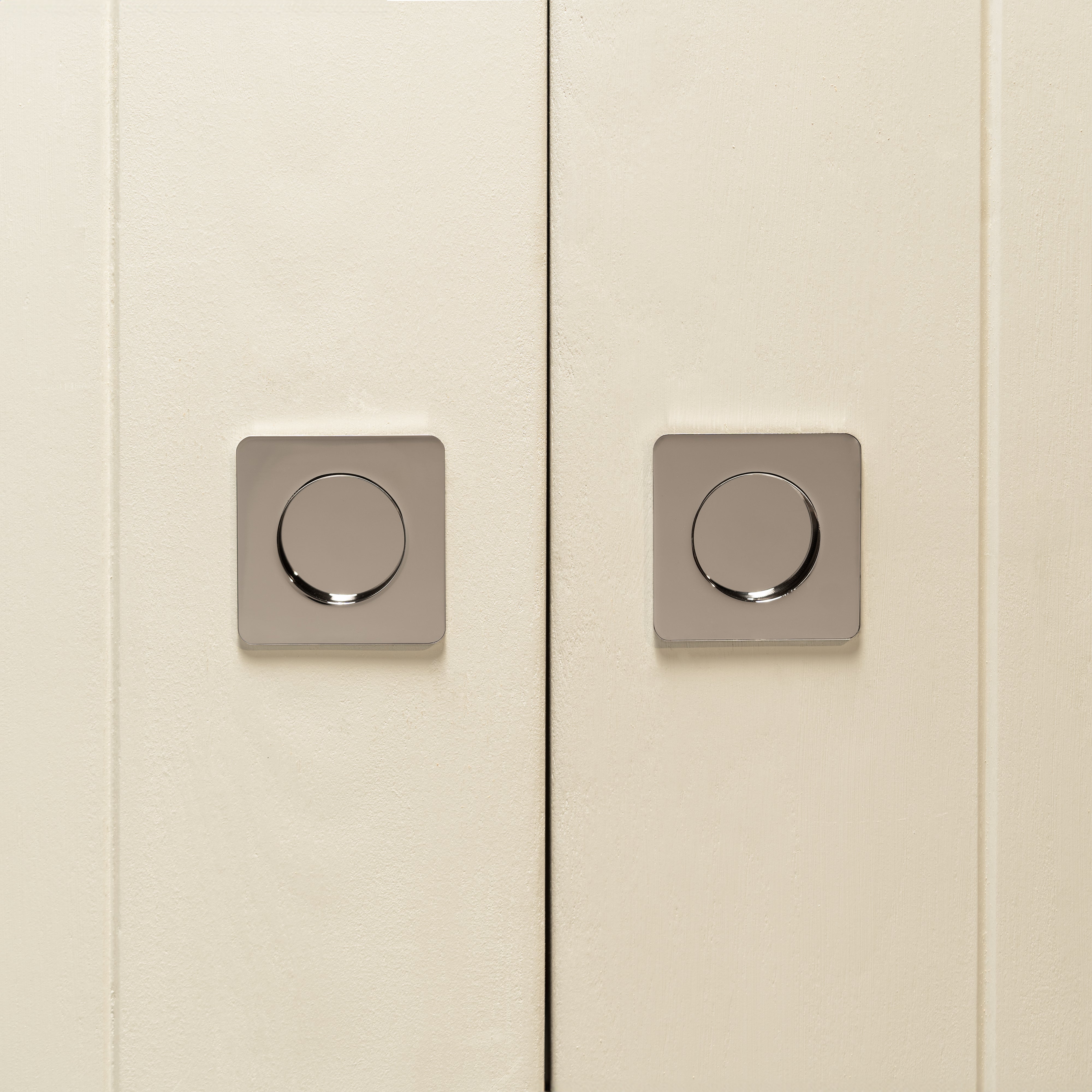 Pair of cabinet doors with Regent Recessed Small Pull handles in polished nickel, showing a sleek round design.