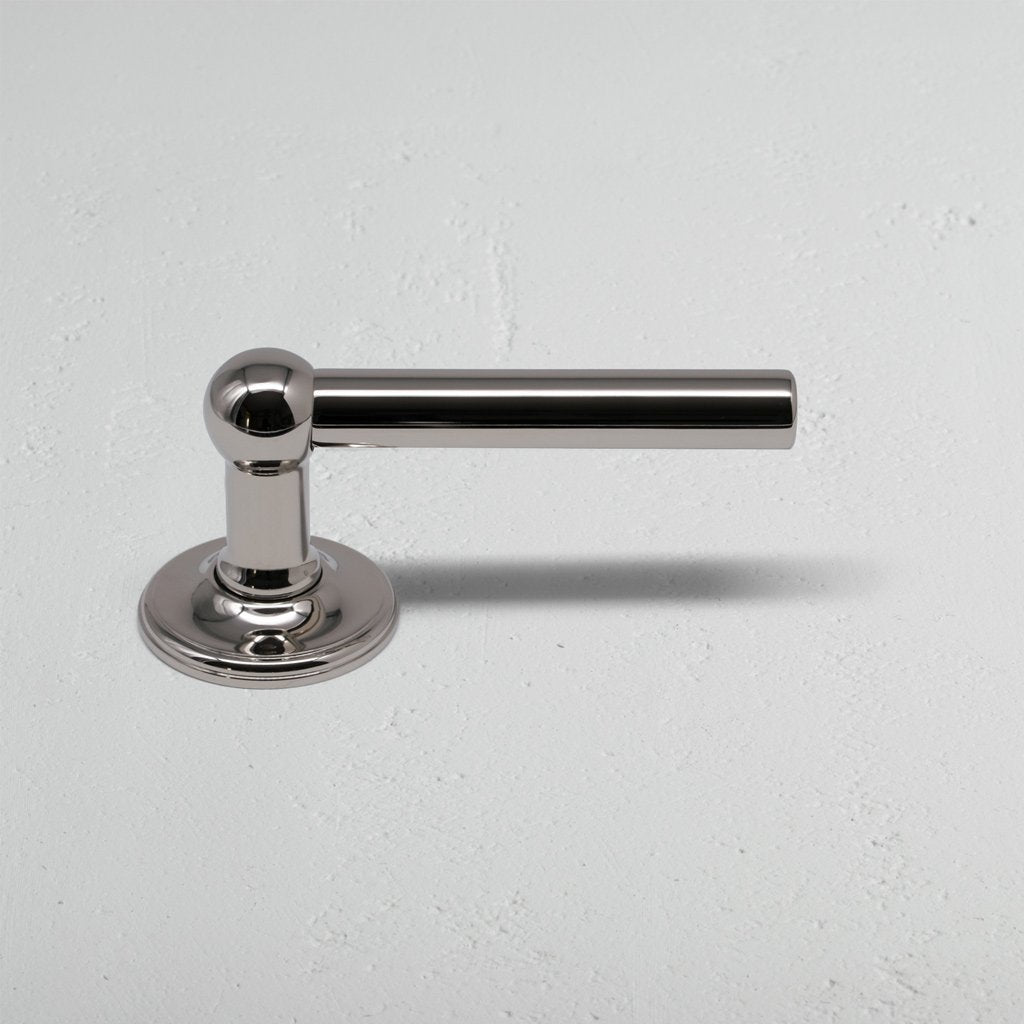 Harper Dummy Door Handle Set in polished nickel with a sleek cylindrical handle on a round base.