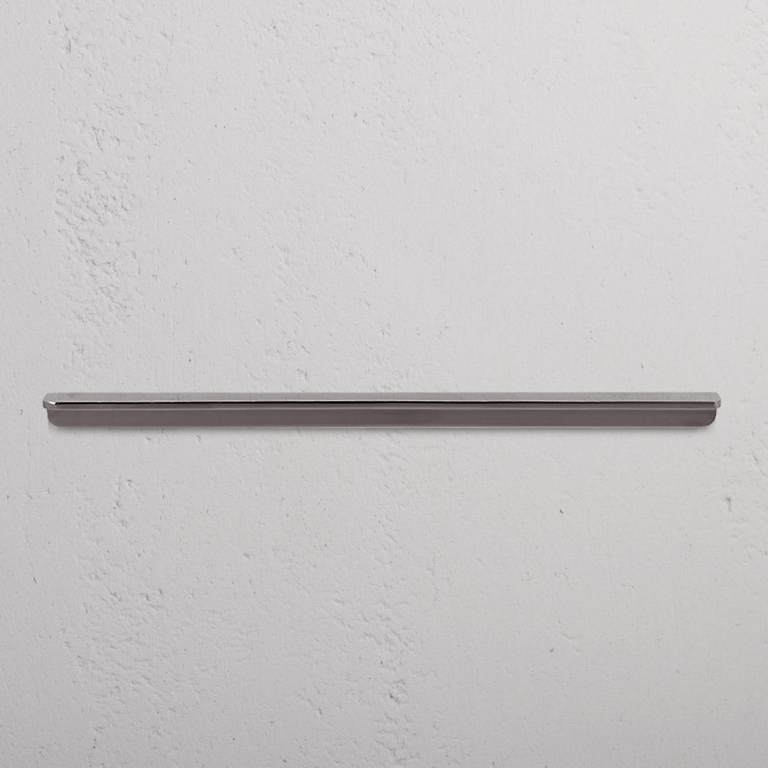 Large Oxford Furniture Handle in polished nickel, mounted horizontally on a white textured wall.