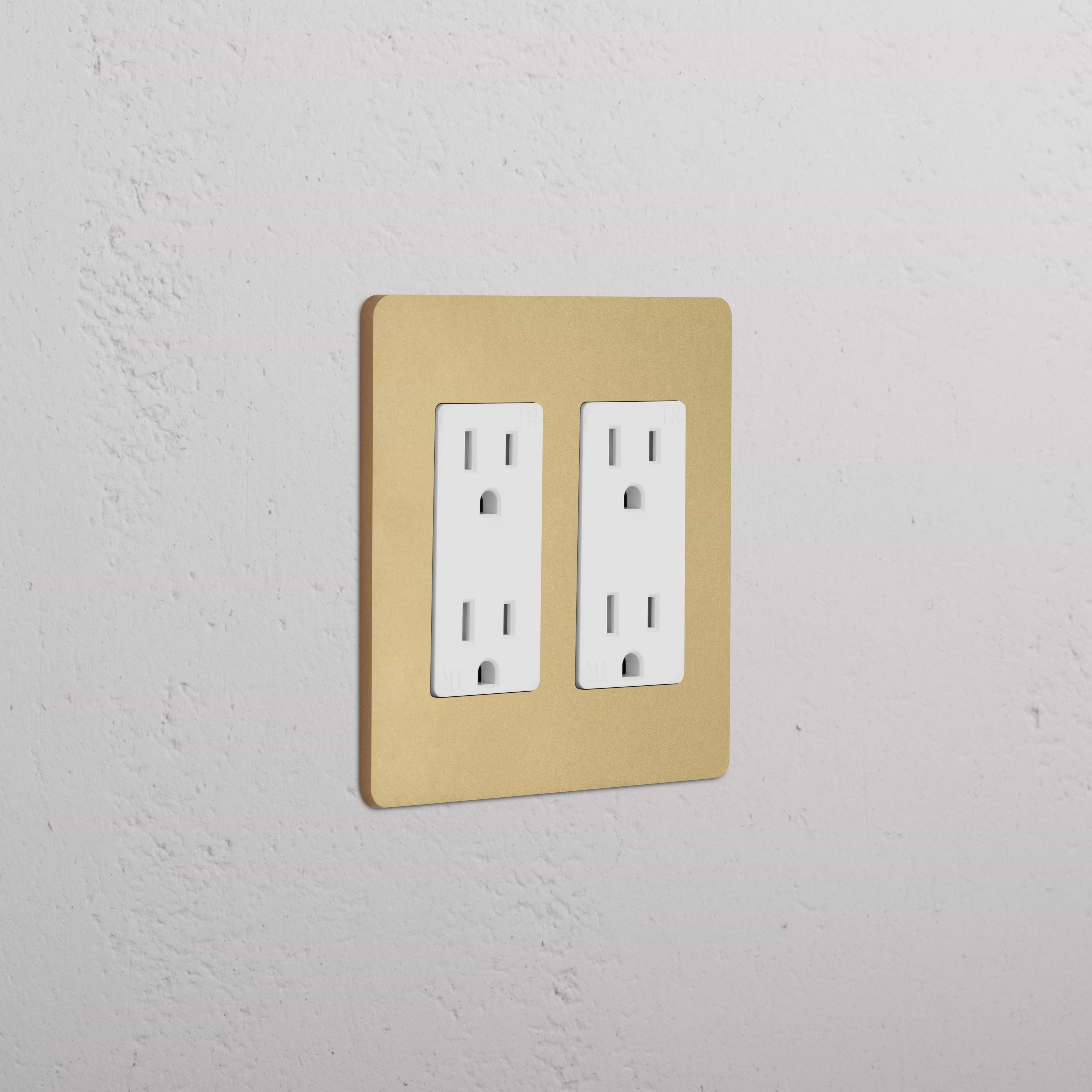 Grove 2G Outlet in Antique Brass White finish, double socket mounted on a white textured wall.