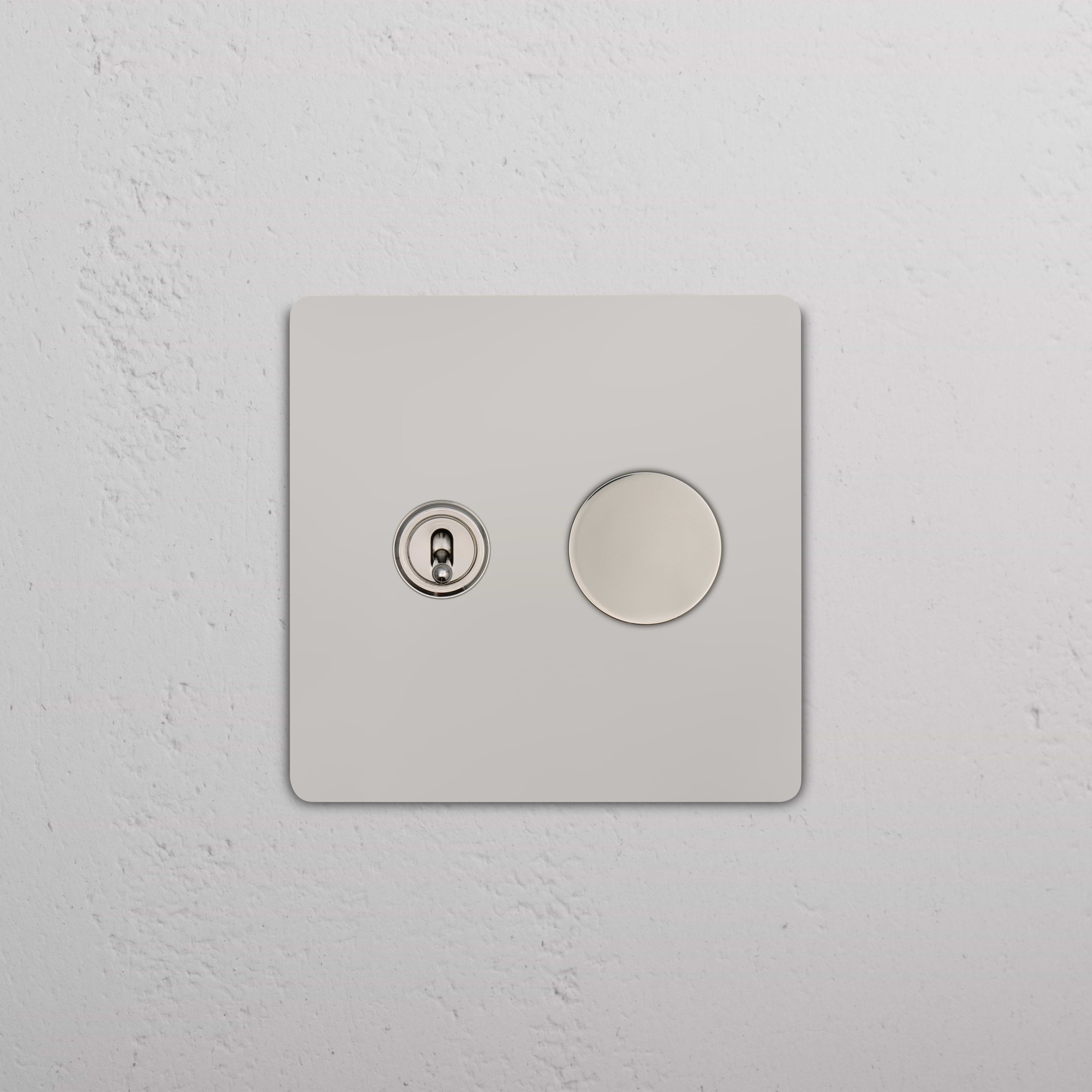 Close-up of Grove 2G Toggle & Dimmer Switch in polished nickel, mounted on a square wall plate.