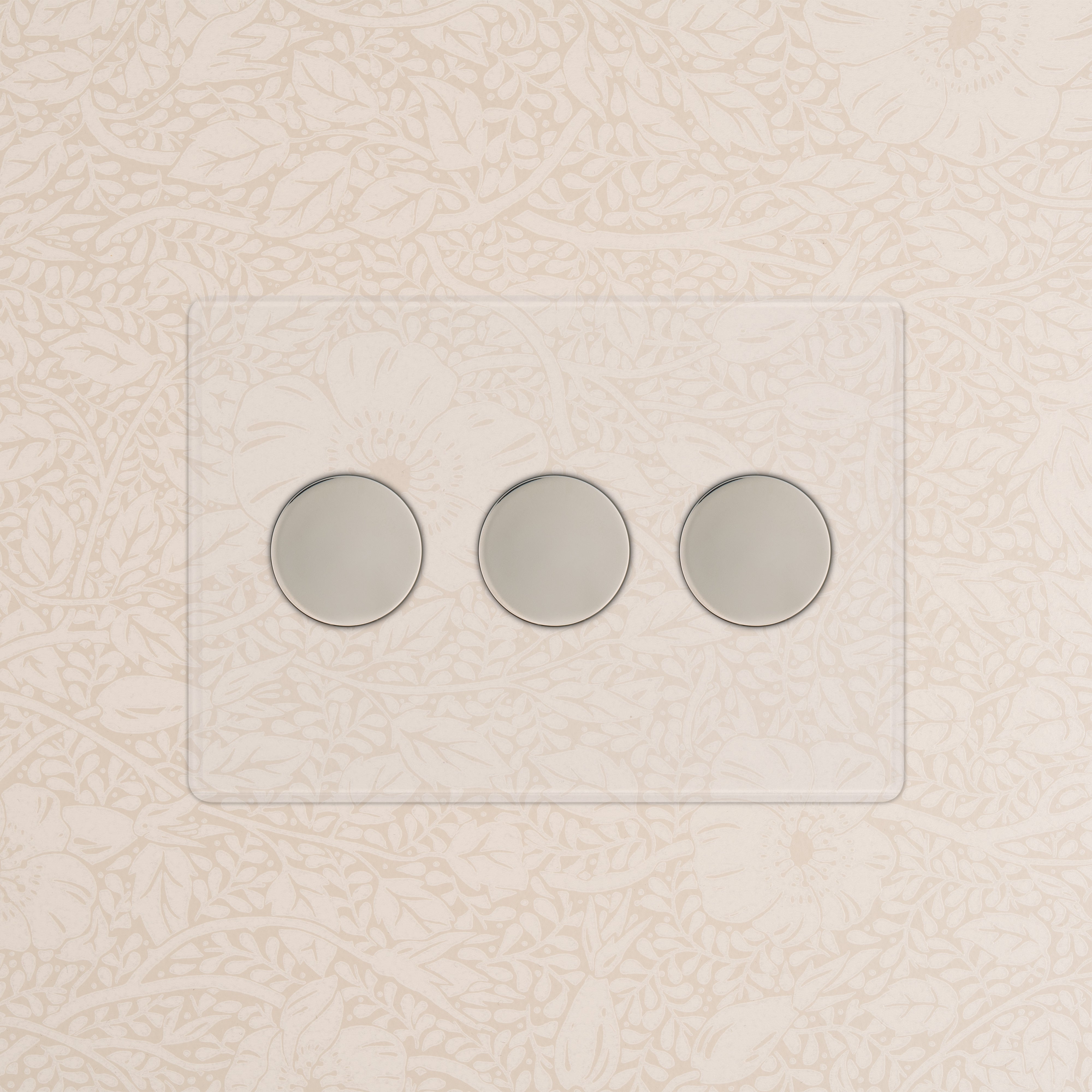 Kew 3G Dimmer Switch in clear polished nickel with three round dials, mounted on a floral wallpapered wall.