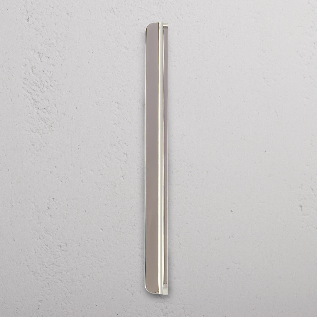 Oxford Furniture Handle Medium in polished nickel, featuring a rounded design, mounted on a light gray surface.