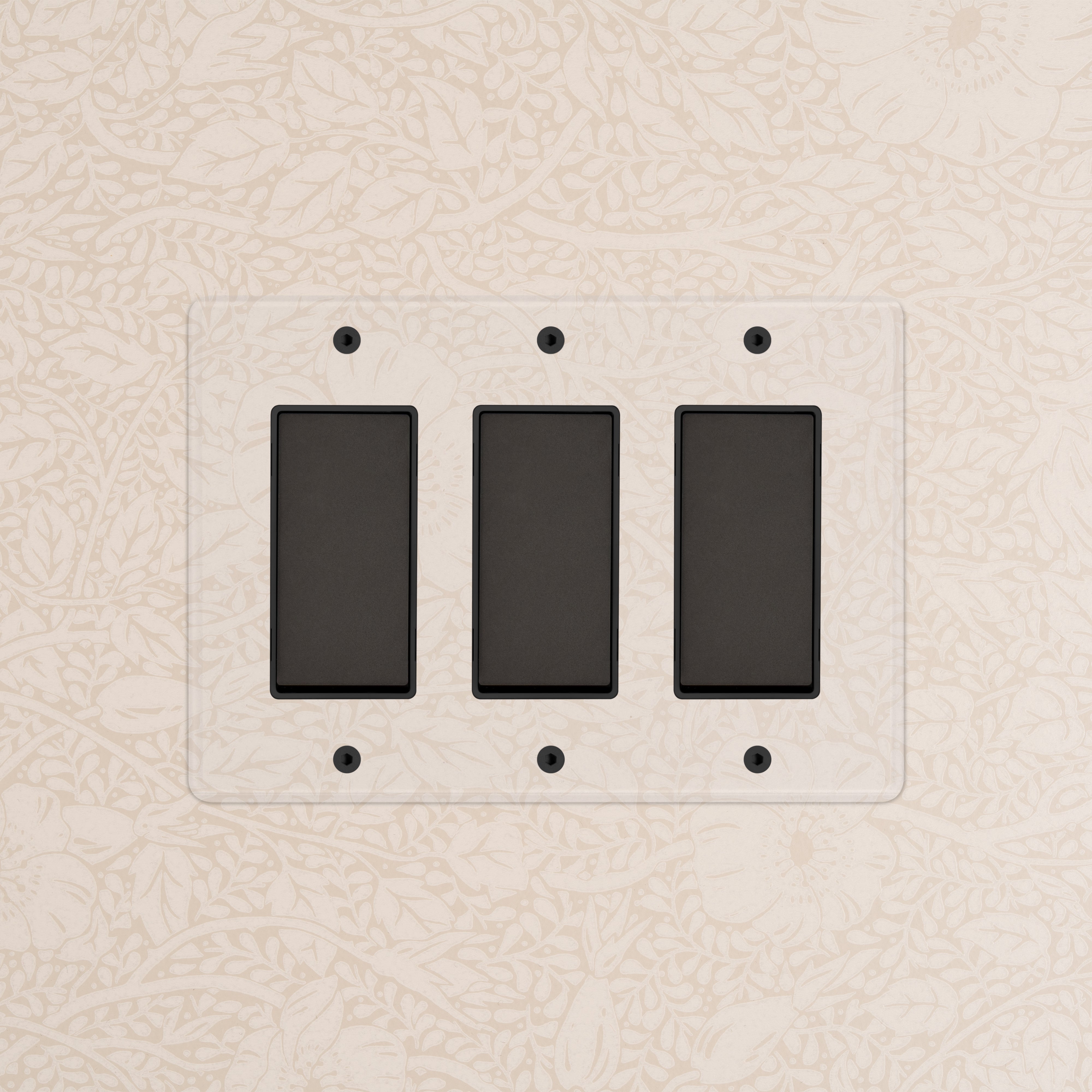 Kew 3G Rocker Switch in Clear Bronze Black finish with three rectangular switches on a decorative wall.