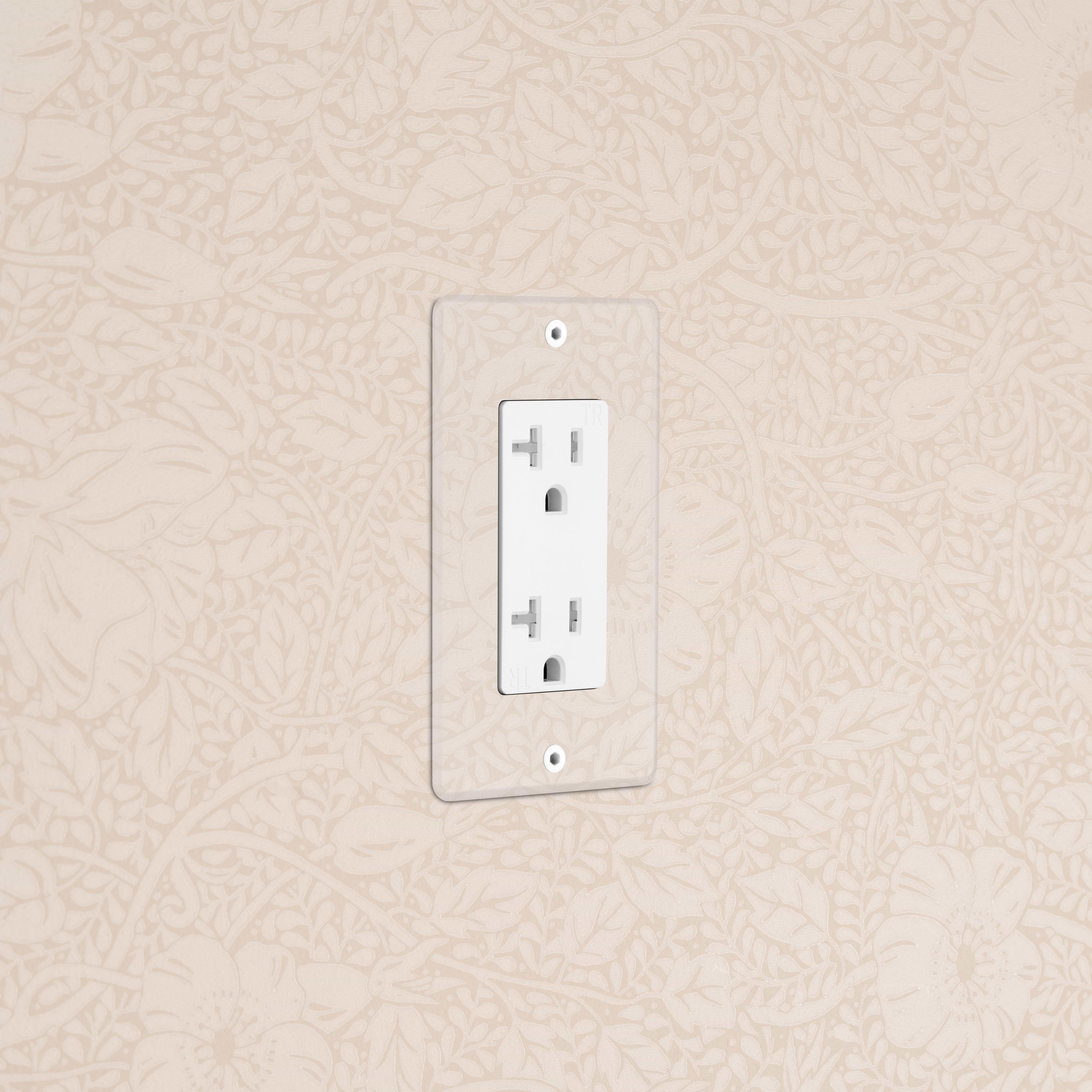 Kew 1G 20A Outlet in Clear White finish, single socket, mounted on beige floral-patterned wall.
